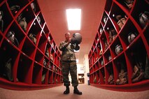 MINOT AIR FORCE BASE, N.D. -- Airman 1st Class Jose Rodriguez, 5th Operation Support Squadron, looks over a helmet strap at the 23rd Bomb Squadron helmet maintenance shop here Sept. 25. Airman Rodriguez maintains aircrew equipment for the life support section. (U.S. Air Force photo by Senior Airman Christopher Boitz)