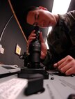 MINOT AIR FORCE BASE, N.D. -- Airman 1st Class Jose Rodriguez, 5th Operation Support Squadron, inspects a pair of night vision goggles for fog and makes sure they are in good working condition at the 23rd Bomb Squadron helmet maintenance shop here Sept. 25. Airman Rodriguez maintains aircrew equipment for the life support section. (U.S. Air Force photo by Senior Airman Christopher Boitz) 