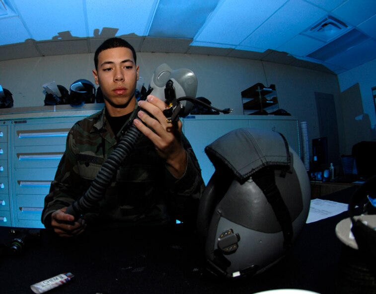 MINOT AIR FORCE BASE, N.D. - Airman 1st Class Jose Rodriguez, 5th Operation Support Squadron, inspects a mask for holes and cracks at the 23rd Bomb Squadron helmet maintenance shop here Sept. 25. Airman Rodriguez maintains aircrew equipment for the life support section. (U.S. Air Force photo by Senior Airman Christopher Boitz) 