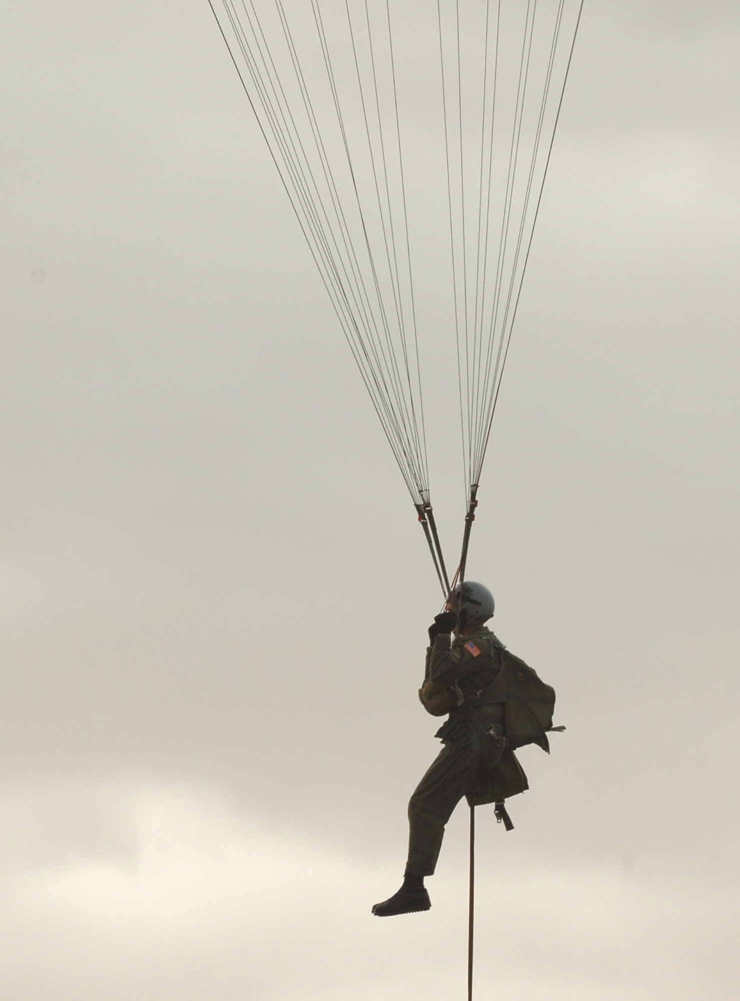 Senior Airman Brian Daubert prepares to land during a parachute jump demonstration Sept. 18 during survival, evasion, resistance and escape training at Fairchild Air Force Base, Wash. SERE specialists provide weekly demonstrations to show students the performance characteristics of the C-9 emergency egress parachute. The jump demo and combat, search and rescue demo are integrated seamlessly into one large demonstration in order for the students to see the entire sequence of events from the moment they egress the aircraft until they are recovered by friendly forces. (U.S. Air Force photo/Airman 1st Class Jocelyn Ford) 
