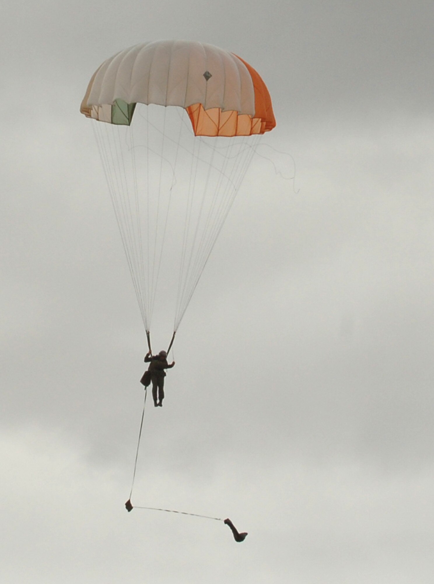Senior Airman Brian Daubert prepares to land during a parachute jump demonstration Sept. 18 during survival, evasion, resistance and escape training at Fairchild Air Force Base, Wash. SERE specialists provide weekly demonstrations to show students the performance characteristics of the C-9 emergency egress parachute. The deomos allow students to see firsthand the techniques they've learned in the SERE school. After all jumpers are safely on the ground, one of the parachutists becomes the isolated person, known as the IP or survivor. This begins the combat search and rescue demonstration. The IP demonstrates techniques a student may use to be recovered should they ever find themselves in a "downed-aircrew" situation. (U.S. Air Force photo/Airman 1st Class Jocelyn Ford) 