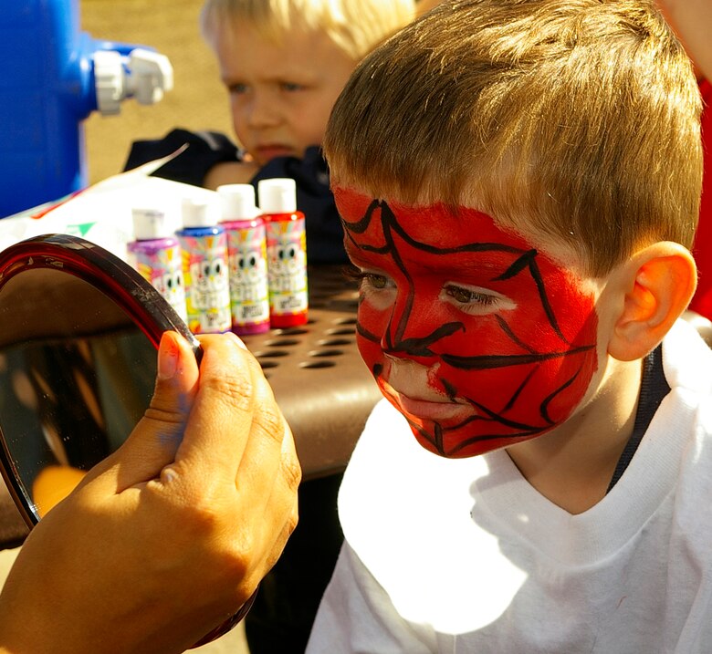 Tate Humphries, 3, closely inspects his Spiderman face painting at the Day for Kids Sept. 15 at the youth center. (U.S. Air Force photo by Karen Abeyasekere)