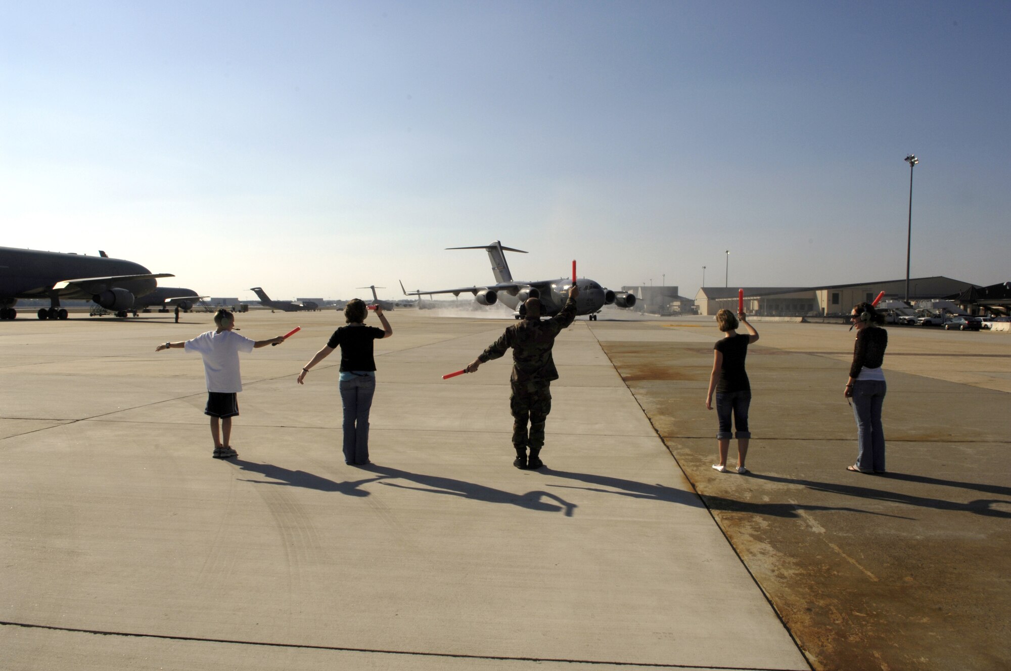 Col. Rick Martin's children Chris, Heather, Holly and Heidi marshal in his C-17 Globemaster III following his fini-flight. Colonel Martin is scheduled to relinquish command to Col. Balan Ayyar, 319th Air Refueling Wing, Grand Forks Air Force Base, N.D., during a change of command ceremony Oct. 2. (U.S. Air Force photo/Kenn Mann)