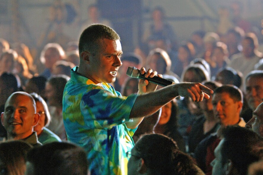 Senior Airman Nicholas Amari, Tops In Blue vocalist, sings on Ramstein Air Base, Germany, Sept. 25. This year's Tops In Blue performance is titled "The Fly-By" and is a musical tribute to 60 years of Air Force history. (U.S. Air Force photo/Airman 1st Class Marc I. Lane)