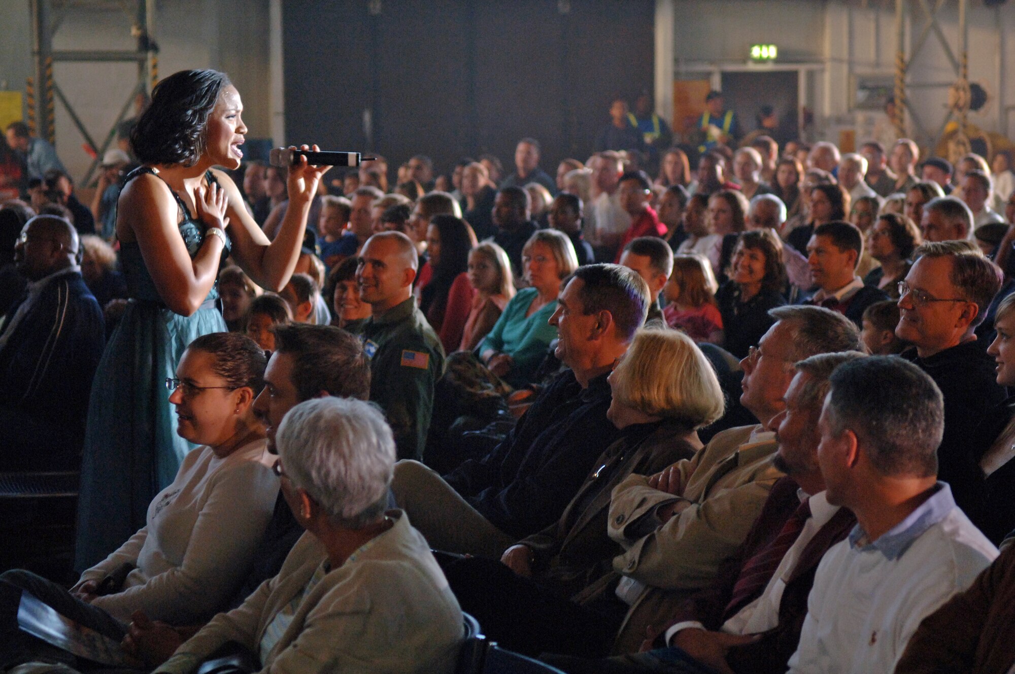 Senior Airman Wallis Payano, Tops In Blue vocalist, sings on Ramstein Air Base, Germany, Sept. 25. This year's Tops In Blue performance is titled "The Fly-By" and is a musical tribute to 60 years of proud Air Force history. (U.S. Air Force photo/Airman 1st Class Marc I. Lane)