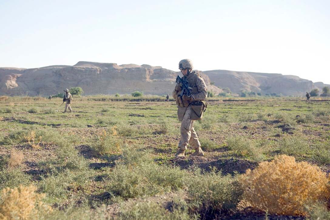 EXPEDITIONARY PATROL BASE - DULAB, Iraq, (Sept. 26, 2007) – Second Lt. Andrew D. Markoff (center), a platoon commander with Company A, 1st Battalion, 7th Marine Regiment, Regimental Combat Team 2, walks across a small clearing while on a cache sweep. The sweep is part of the battalion’s strategy to counter a suspected increase of enemy activity during the Muslim holy month of Ramadan. (Official USMC photograph by Cpl. Shane S. Keller)