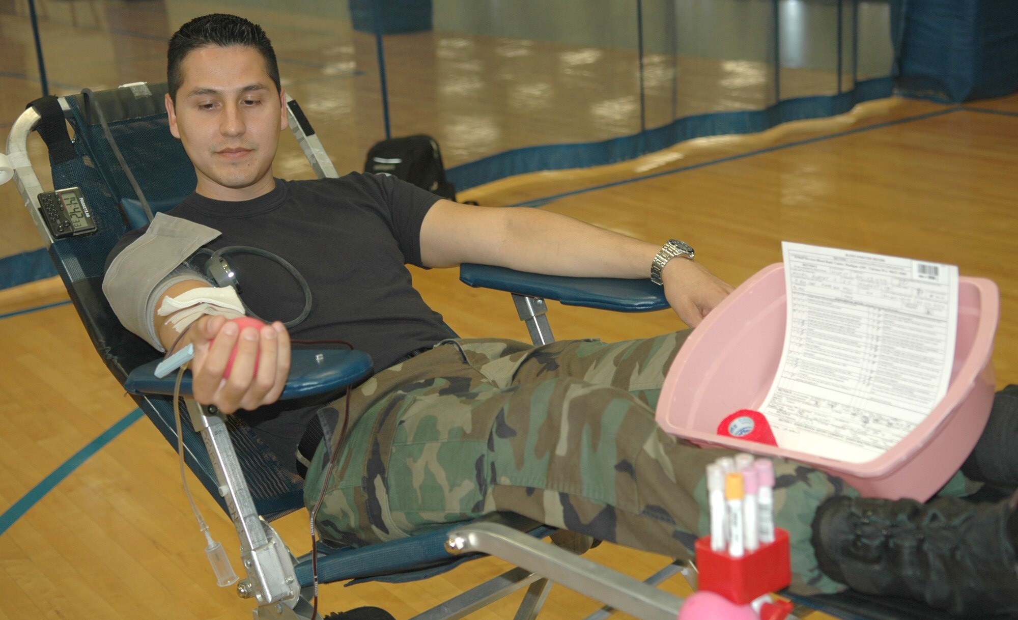 FAIRCHILD AIR FORCE BASE, Wash. -- Staff Sgt. Gil Madril, 92nd Maintenance Operations Squadron maintenance training flight instructor, donates blood to the Armed Services Blood Bank Center Pacific Northwest at the Fitness Center here Sep. 25. The blood is gathered from anyone associated with the Department of Defense to be used in Iraq and Afghanistan by U.S. forces.  Fairchild was the first stop for the blood bank center in their coverage of Eastern Washington. (U.S. Air Force photo / Tech. Sgt. Larry W. Carpenter Jr.)