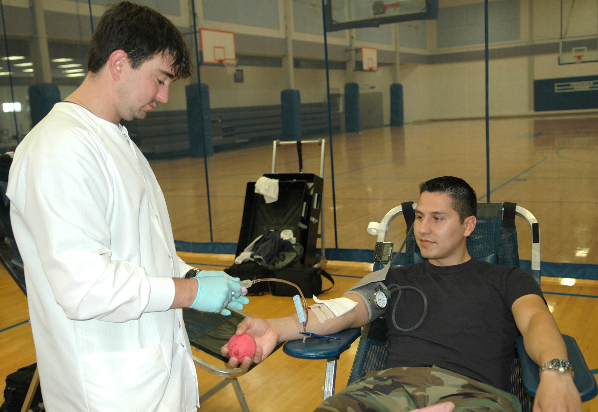 FAIRCHILD AIR FORCE BASE, Wash. -- Tony Darosett, a phlebotomist with the Armed Services Blood Bank Center Pacific Northwest, finishes drawing blood vials from Staff Sgt. Gil Madril, 92nd Maintenance Operations Squadron maintenance training flight instructor during a blood drive here Sept. 25.  Donated blood will be shipped to Iraq and Afghanistan for use by U.S. forces, and to military hospitals in the U.S. (U.S. Air Force photo / Tech. Sgt. Larry W. Carpenter Jr.)