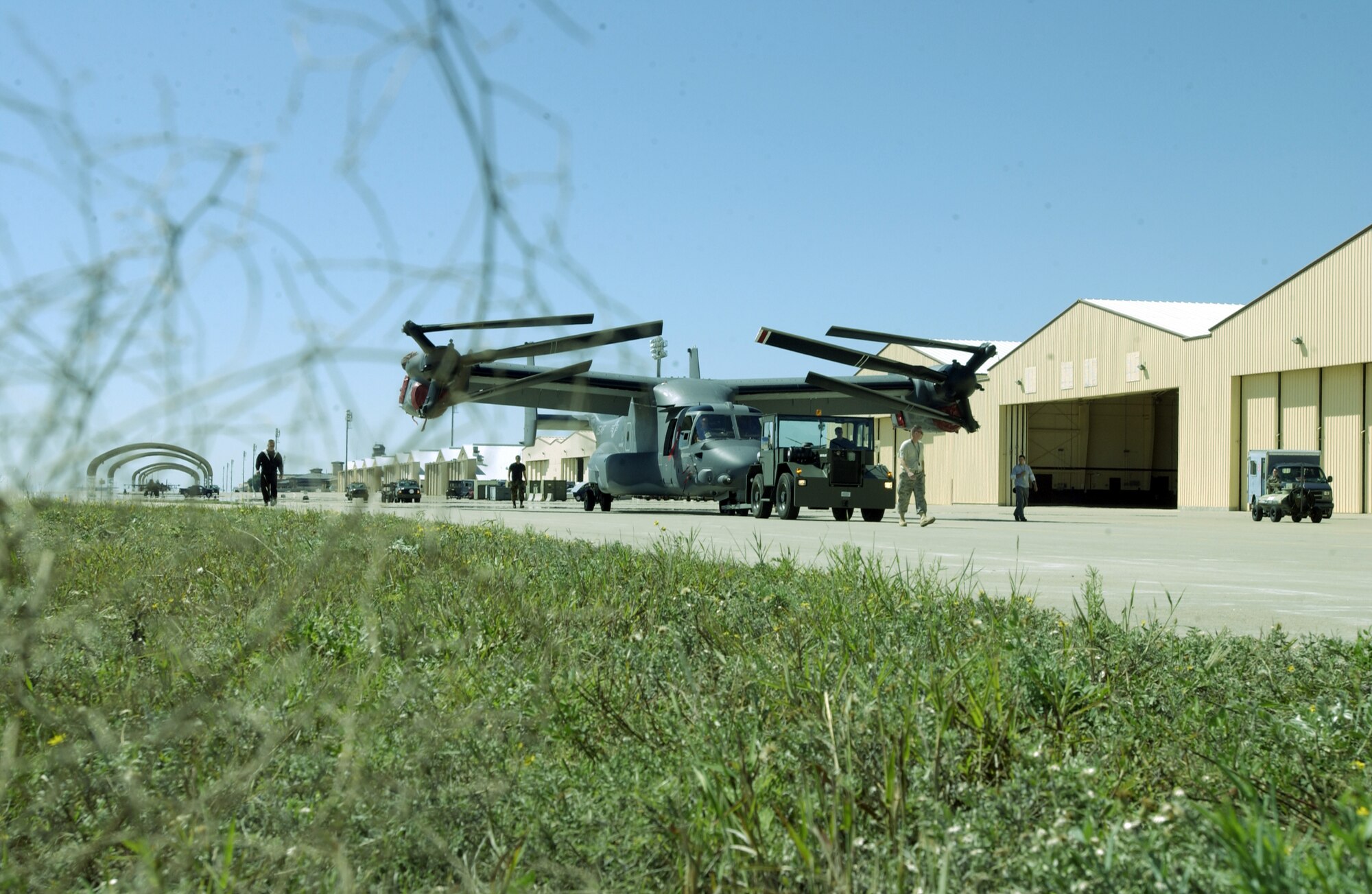 CANNON AIR FORCE BASE, N.M. -- A tumbleweed frames a CV-22 Osprey being towed at Cannon AFB, N.M., on Sept. 25, 2007.  Cannon AFB will be transferred from Air Combat Command to Air Force Special Operations Command on Oct. 1.  Ospreys are among the special operations aircraft that will be assigned to the 27th Special Operations Wing which - as the 27th Fighter wing - flew F-16 Fighting Falcons at the base from 1995 to 2007.  Air Force photo by Greg Allen                               