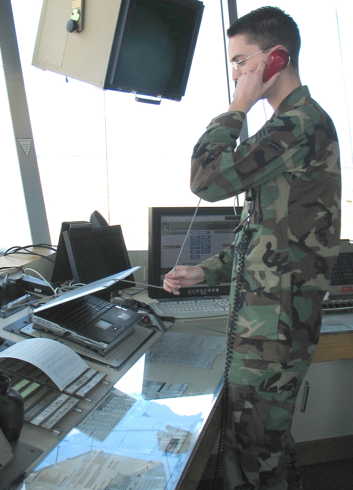 FAIRCHILD AIR FORCE BASE, Wash. – Airman 1st Class Steven Valentine, 92nd Operations Squadron air traffic controller, simulates use of the “crash phone” to notify the base fire department that assistance is needed to conduct an emergency evacuation of the air traffic control tower. When no other option is available, the tower crew must use the Baker’s Life Chute to slide to safety. (U.S. Air Force photo / Airman 1st Class Kali L. Gradishar)