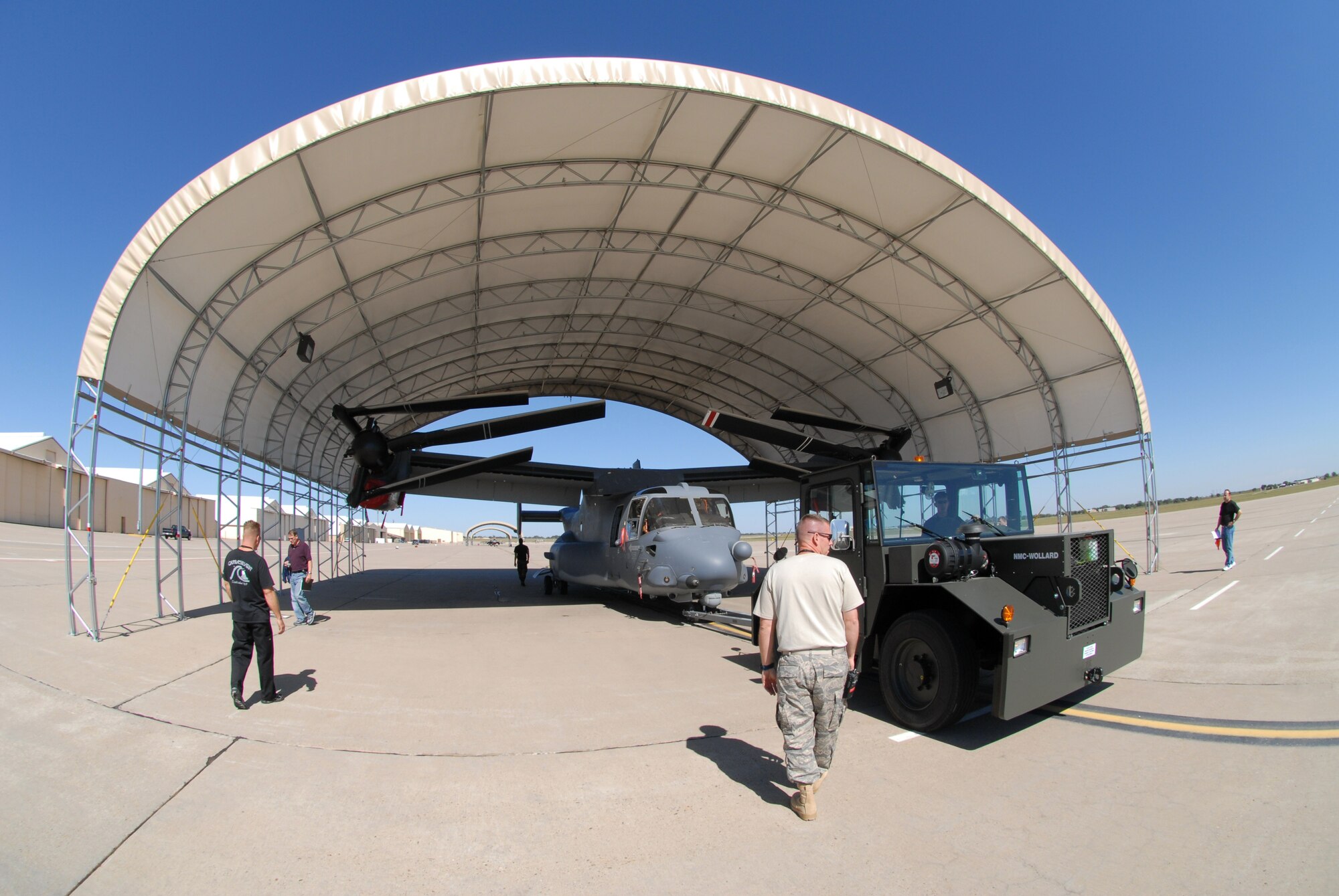 CANNON AIR FORCE BASE, N.M. -- Airmen check the fit of a CV-22 Osprey in a flight line sun shelter on Sept. 25, 2007.  Cannon AFB will be transferred from Air Combat Command to Air Force Special Operations Command on Oct. 1.  Ospreys are among the special operations aircraft to be assigned to the 27th Special Operations Wing at Cannon.  The wing, formerly designated the 27th Fighter Wing, operated F-16 Fighting Falcons at the base from 1995 to 2007.  (Air Force photo by Chief Master Sgt. Gary Emery)