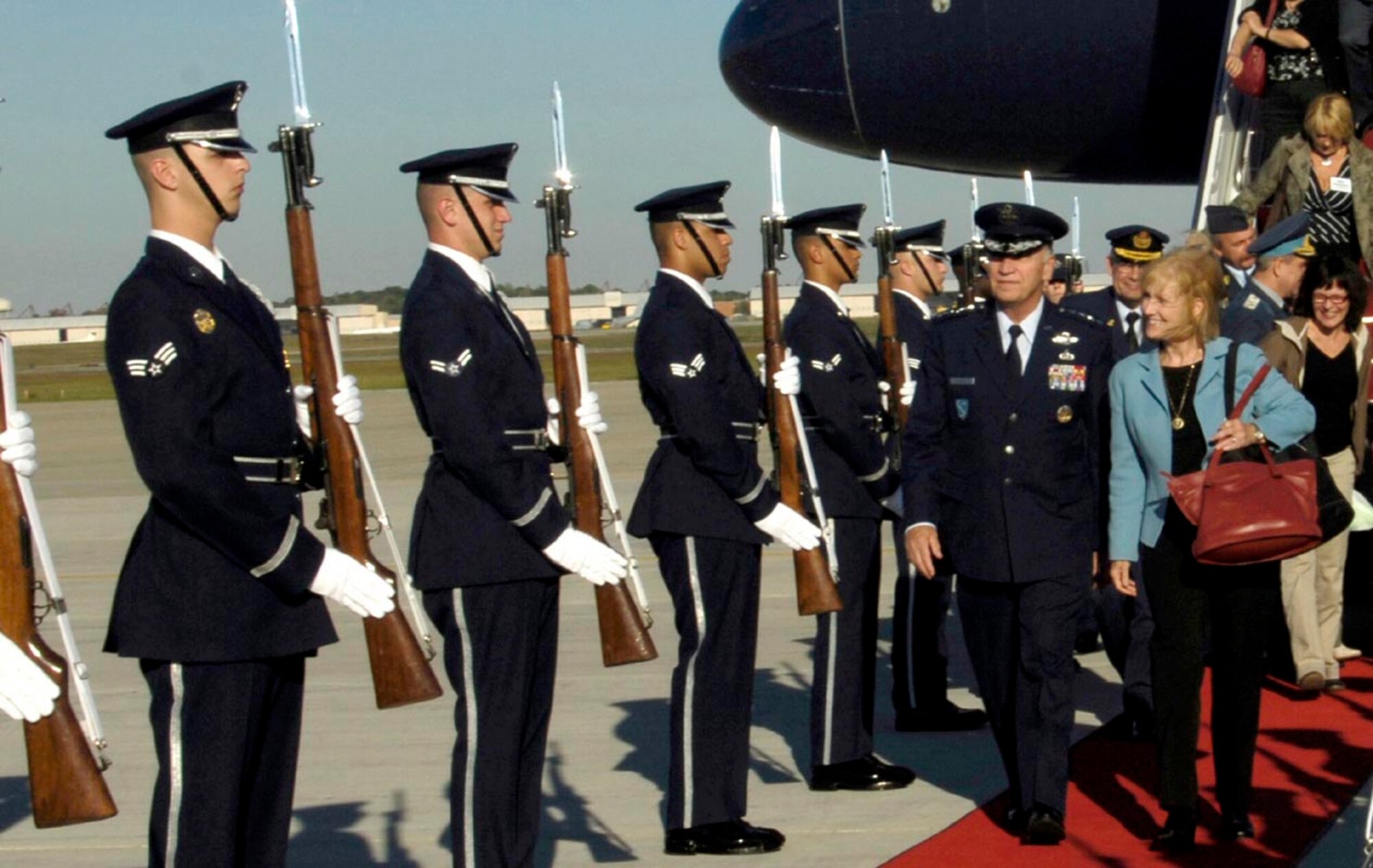 General William T. Hobbins, Commander U.S. Air Forces Europe and his wife Robbin walk down a red carpet lines with Honor Guard members presenting arms Sept. 21. General Hobbins visited from Europe to attend the Global Air Chiefs conference.