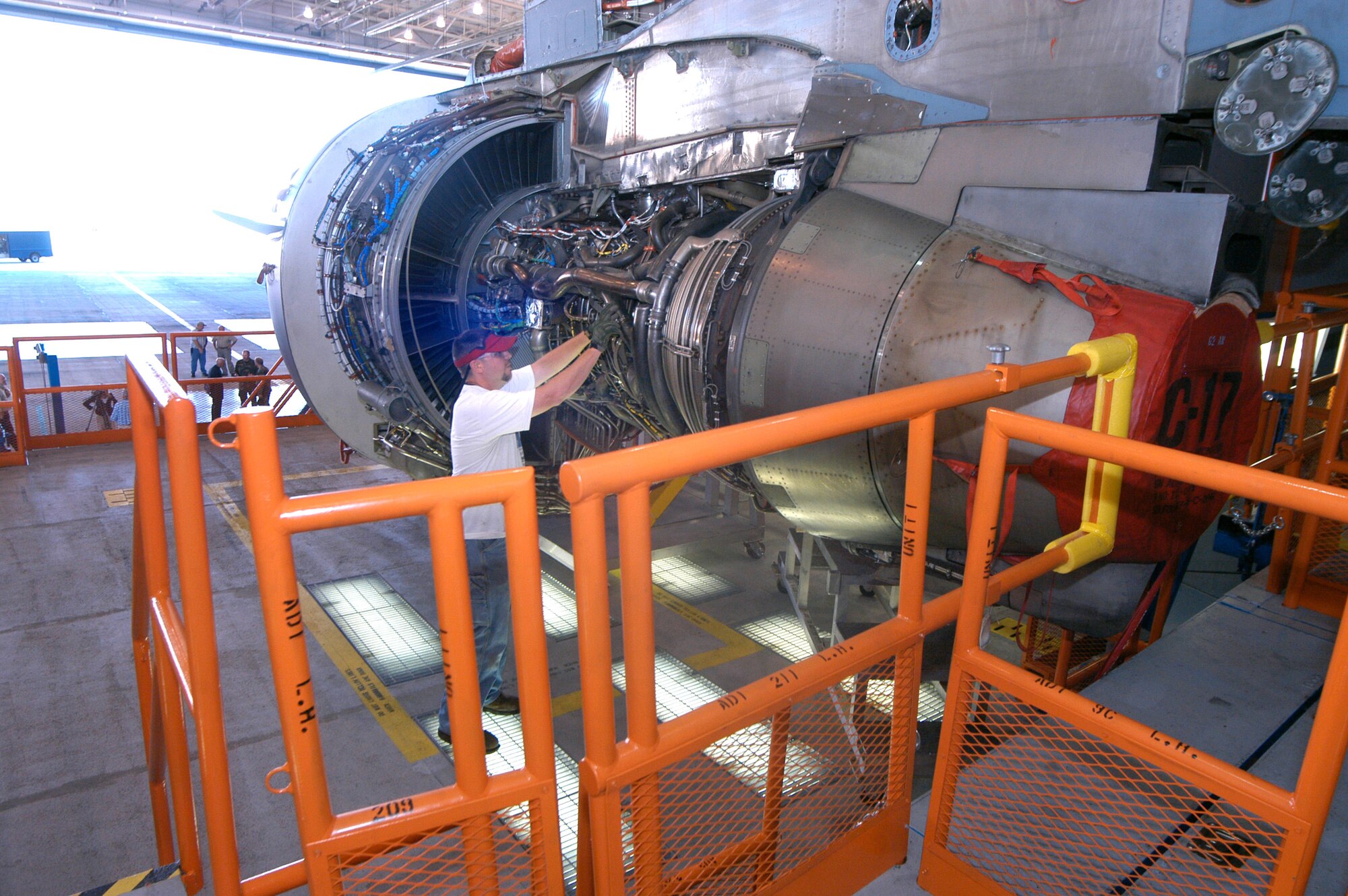 Aircraft mechanic Mitch Faraone demonstrates how accessible the engine on the C-17 Globemaster III is on the new underwing maintenance platform Sept. 17 at Robins Air Force Base, Ga. (U.S. Air Force photo/Sue Sapp) 