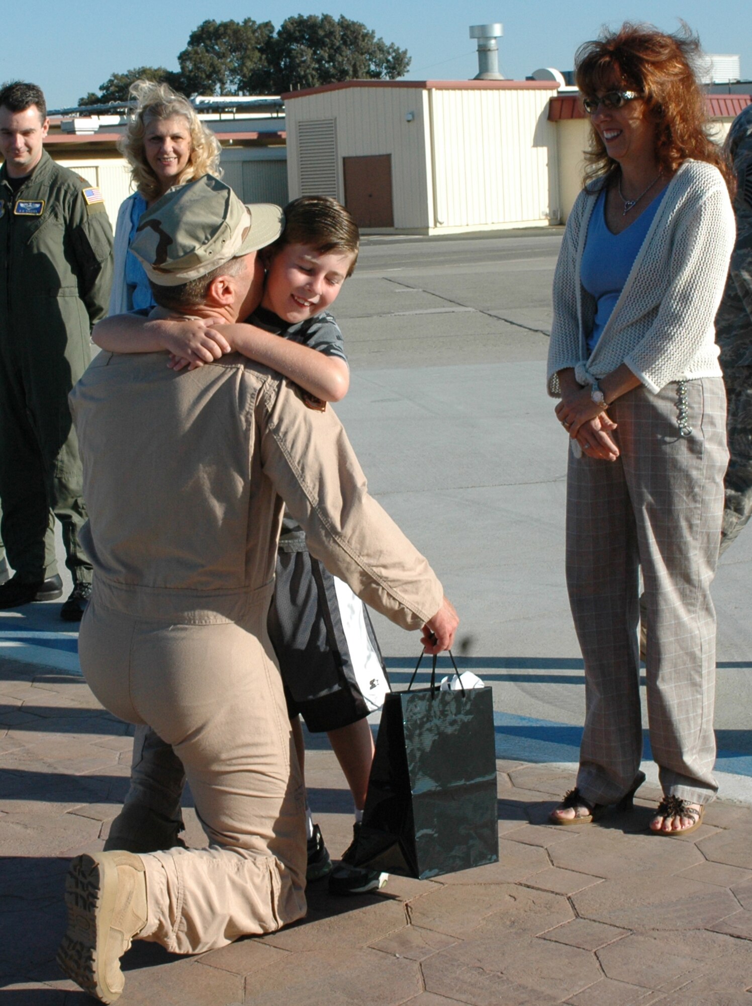 Col. Steve Arquiette, 60th Air Mobility Wing commander, hugs his son, Stevie, as he prepares to leave for a deployment. Colonel Arquiette will serve as the Deputy Director of Mobility Forces for Southwest Asia. (U.S. Air Force photo/Airman 1st Class Kristen Rohrer)