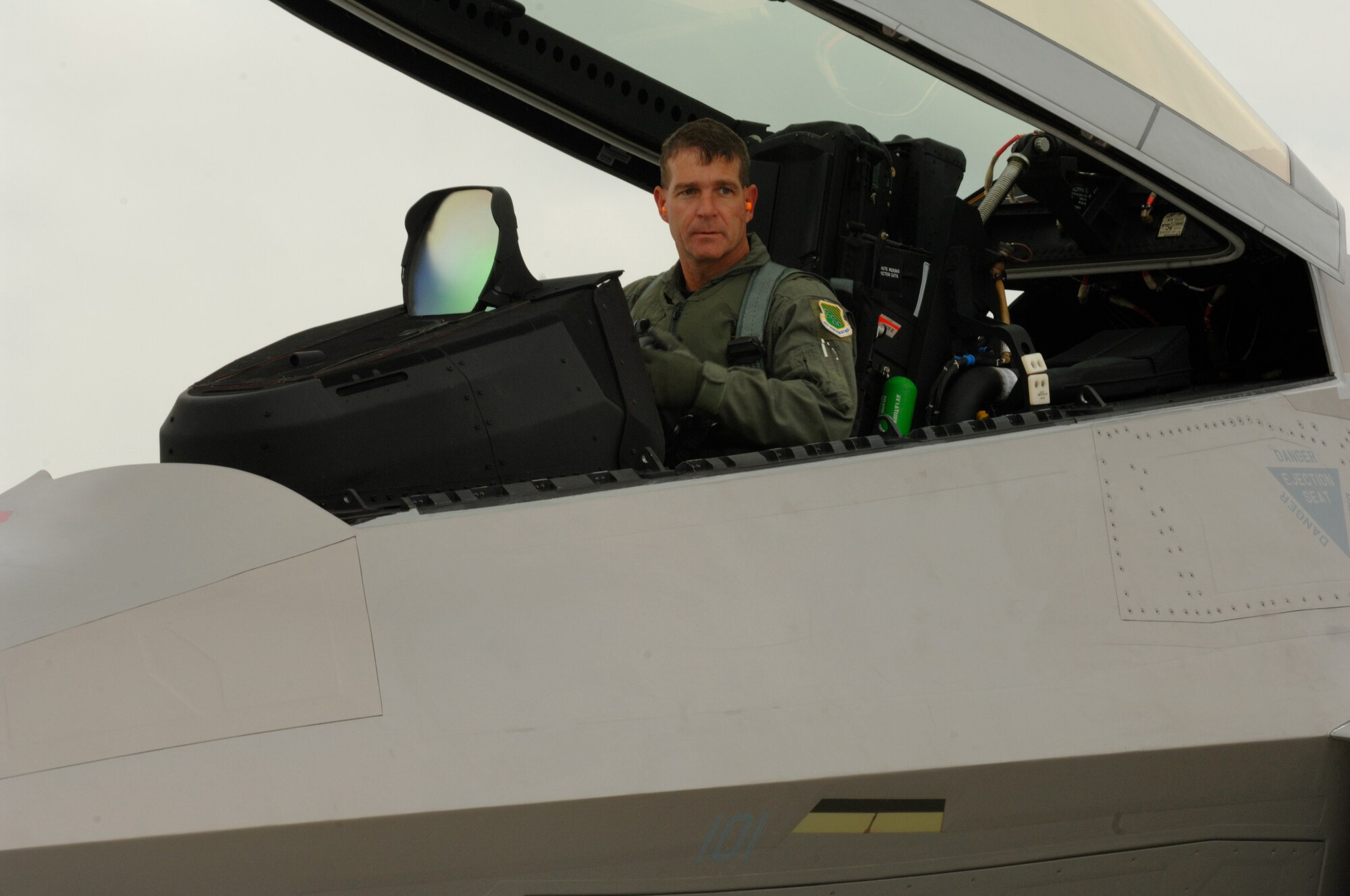 Brig. Gen. Mark Barrett, 1st Fighter Wing commander, opens the canopy of the wing’s new flagship aircraft, tail number 101. The general flew the F-22A from the Lockheed Martin factory in Marietta, Ga., to Langley Sept. 27. "A flagship shows that the leadership flies and leads the wing from the front," General Barrett said after landing the Raptor. (U.S. Air Force photo/Senior Airman Christopher L. Ingersoll)