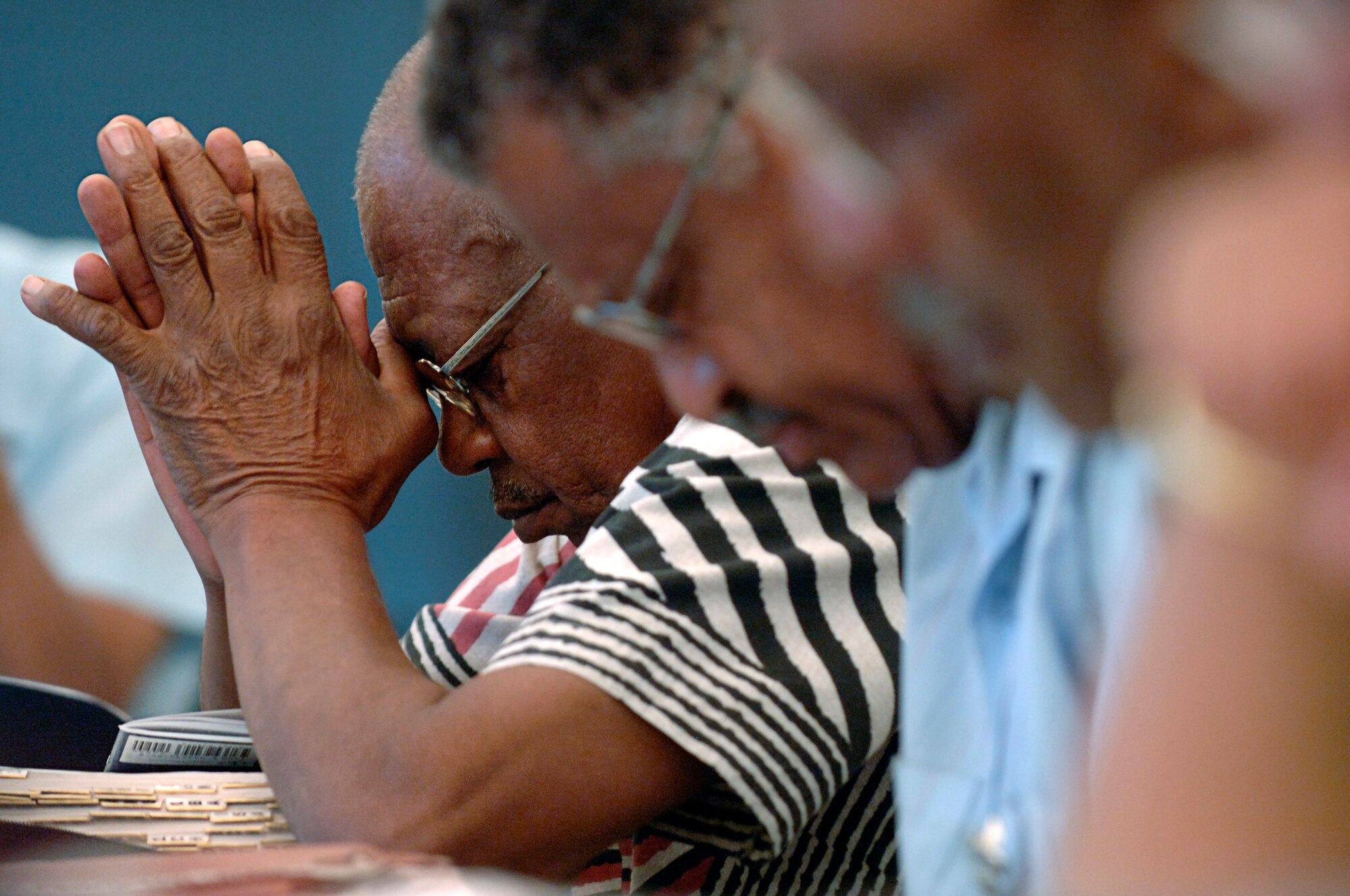 LANGLEY AIR FORCE BASE, Va. -- Guy Barber pauses for a moment to say a prayer during the Terrific Tuesday Bible Study at the Langley Chapel Annex Sept. 25. Members of the Bible study gather Tuesdays at 5 p.m. for an interactive bible study, prayer and food. Although many members are from Langley , people of all ages from neighboring communities are encouraged to participate. (U.S. Air Force photo/Airman 1st Class Vernon Young)