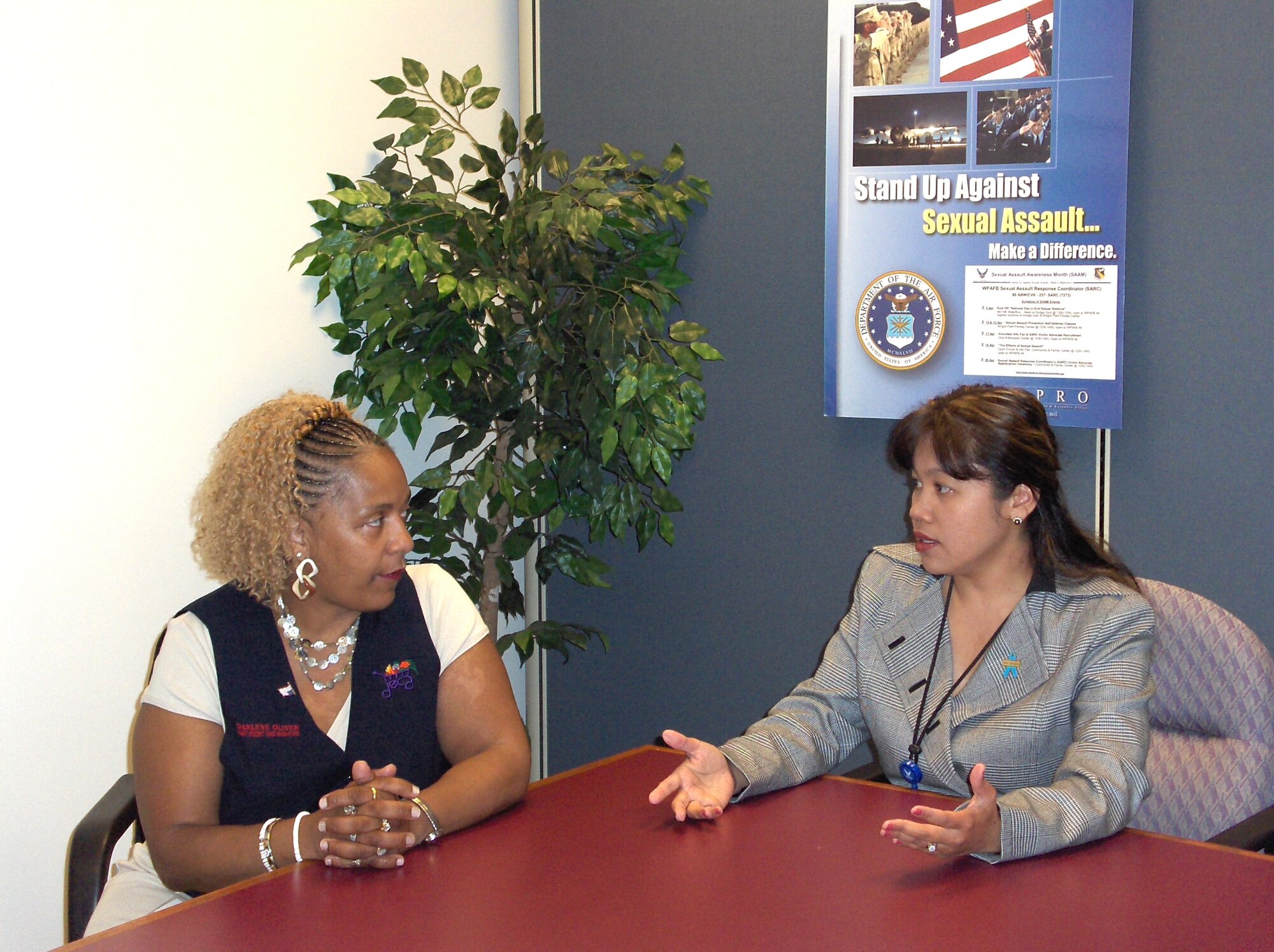Darlene Oliver, assistant front-end manager at the Wright-Patterson Air Force Base Commissary, and Simone Koram, sexual assault response coordinator, discuss the ways in which the commissary can help spread the message of preventing sexual assault as well as how people can learn to become good wingmen to each other. The partnership between the local Defense Commissary Agency and the SARC is a first for Air Force bases, according to Koram. (Air Force photo by Iyesha Jenkins)