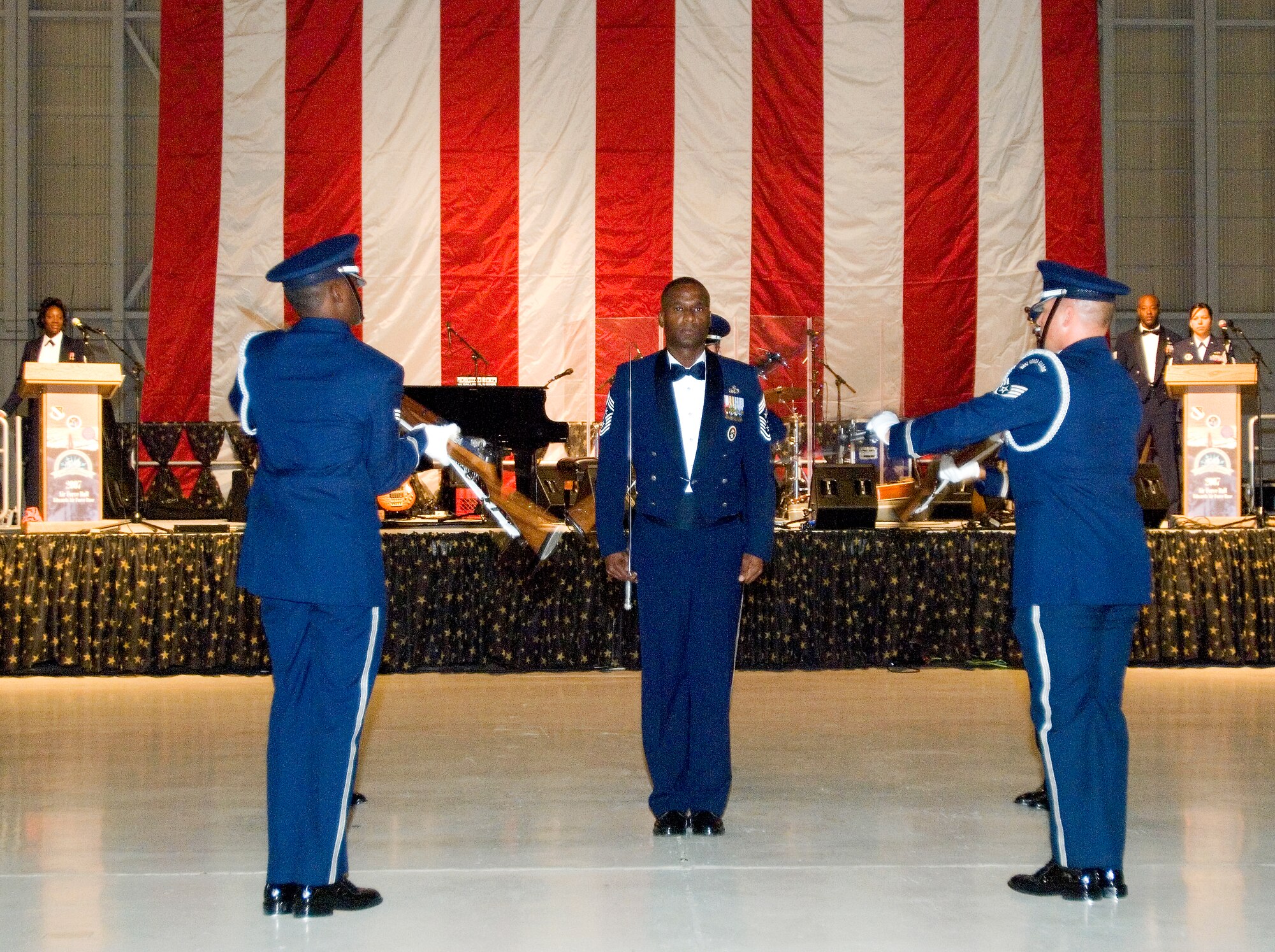 Chief Master Sgt. Juan Lewis, 95th Air Base Wing command chief, stands at attention during the Blue Eagles Honor Guard drill performance at the Edwards Air Force Ball at hangar 1600 here Sept. 21. (Photo by Mike Cassidy)