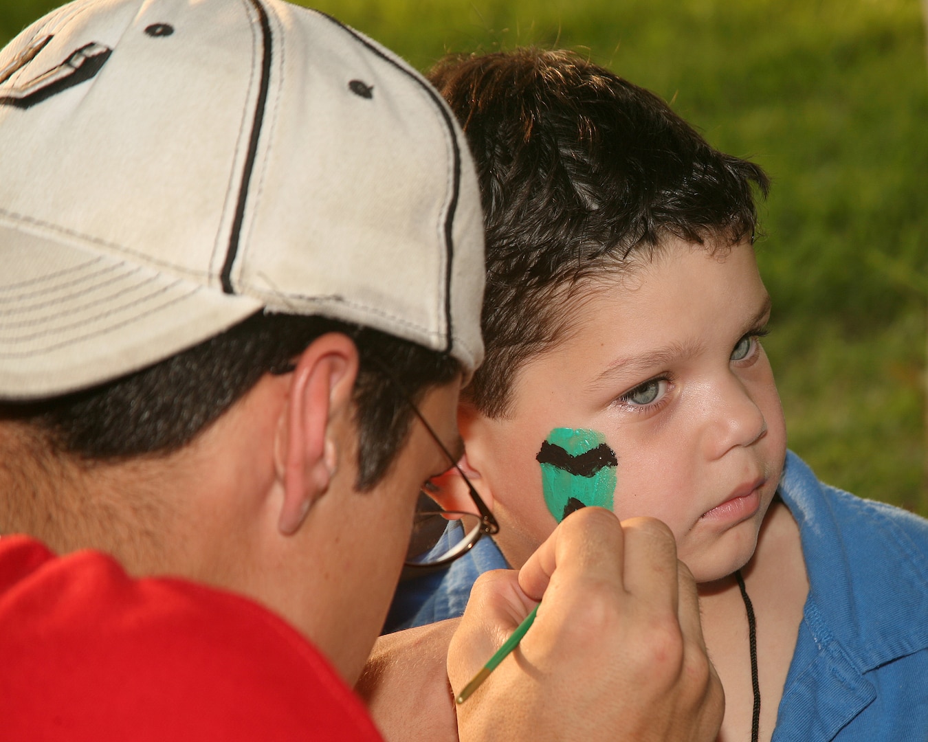 Evan Yanders gets his face painted at the 60th Birthday Bash at the Lackland Air Force Base Gateway Club Sept. 14, 2007. The bash included numerous activities for kids, as well as entertainment and games. Evan is the son of Staff Sgt. Keith Yanders of the 344th Training Squadron. (USAF photo by Robbin Cresswell)