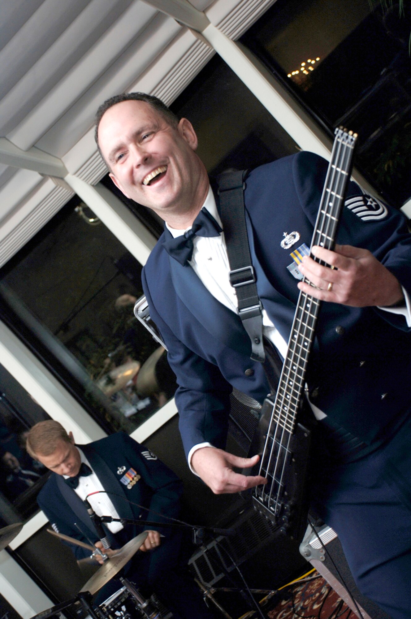 HANSCOM AFB, Mass. -- Tech. Sgt. Kenneth Maurais, U.S. Air Force Band of Liberty, strums a guitar during the SNCO Induction ceremony. (U.S. Air Force photo by Jan Abate)