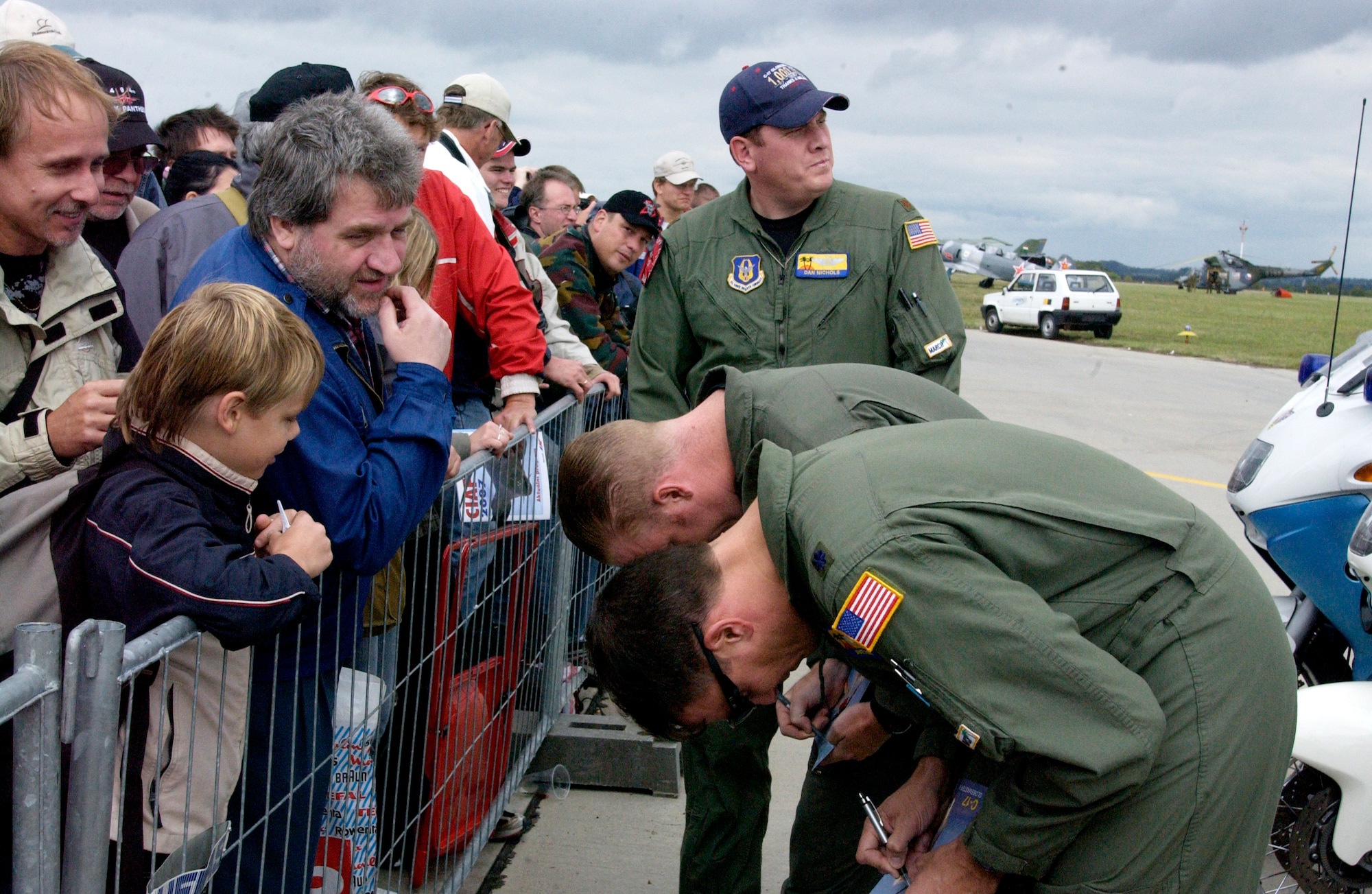 Pilots from Spirit of California from March Air Reserve Base, Calif., sign autographs at the Brno International Air Festival in the Czech Republic. The crew, from the 729th Airlift Squadron, had just completed an aerial demonstration at the air show. (U.S. Air Force photo by Senior Airman David Flaherty)