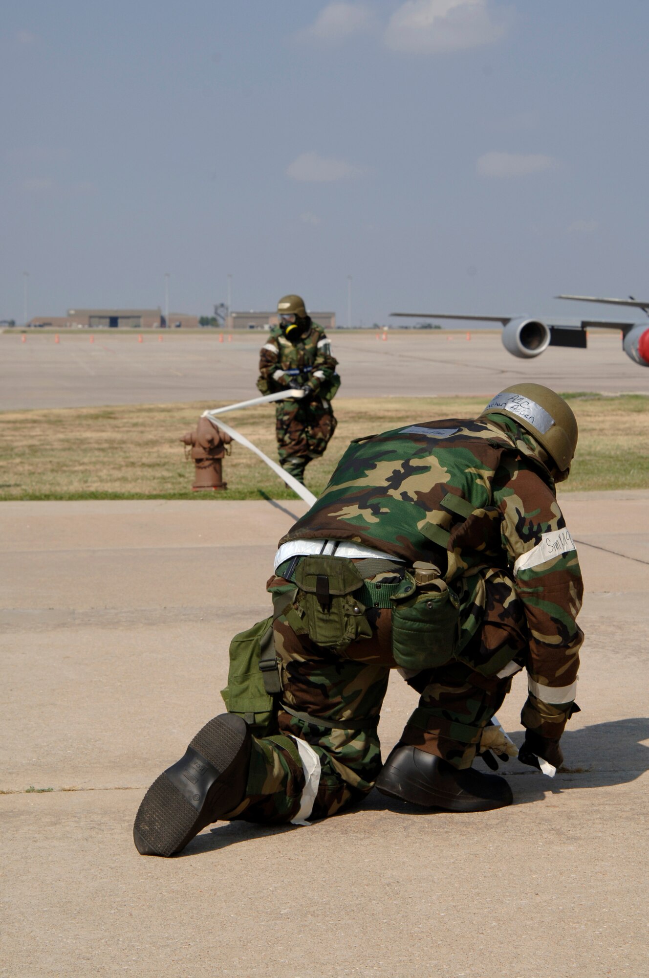 MCCONNELL AIR FORCE BASE, Kan. – Airman 1st Class Jonathon Allen and Staff Sgt. Sabina Myers, 22nd Medical Operation Squadron, section off an area in the exercise play location during the Ability to Survive and Operate exercise Sept. 19. (photo by Airman 1st Class Roy Lynch III)