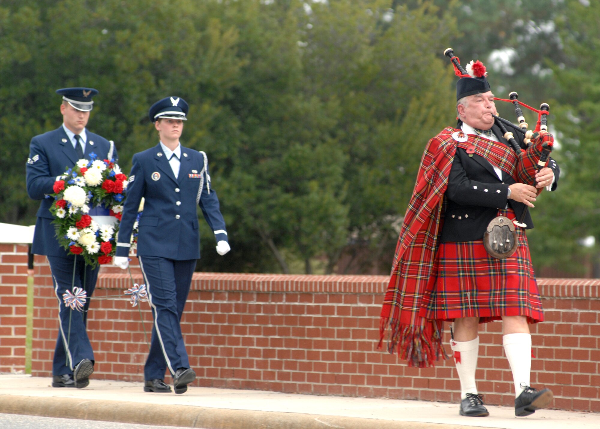 Airmen from the 4th Fighter Wing Honor Gaurd, carry a memorial wreath as they follow the sound of bagpipes during the POW/MIA ceremony on September 21, 2007, Seymour Johnson Air Force Base, Goldsboro North Carolina. The POW/MIA ceremony honors all those who have bravely sacrificed life and so much more for the freedom of the United States.(U.S. Air Force photo by A1C Jonathon Williams)(released)
