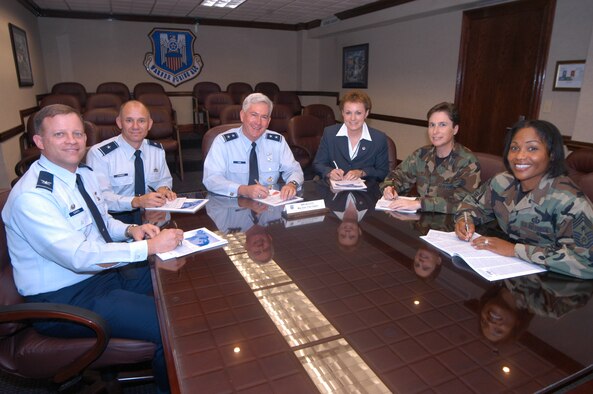 Col. Terence Szanto, 330th Aircraft Sustainment Wing commander, Brig. Gen. Mark Atkinson, 402nd Maintenance Wing commander,  Maj Gen. Tom Owen, WR/ALC commander, Brenda Romine, 542nd CSW director, Col. Theresa Carter, 78th ABW commander, and Chief Master Sgt. Carol Dockery, 78th ABW command chief take time to sign their CFC pledge cards recently. U. S. Air Force photo by Sue Sapp 