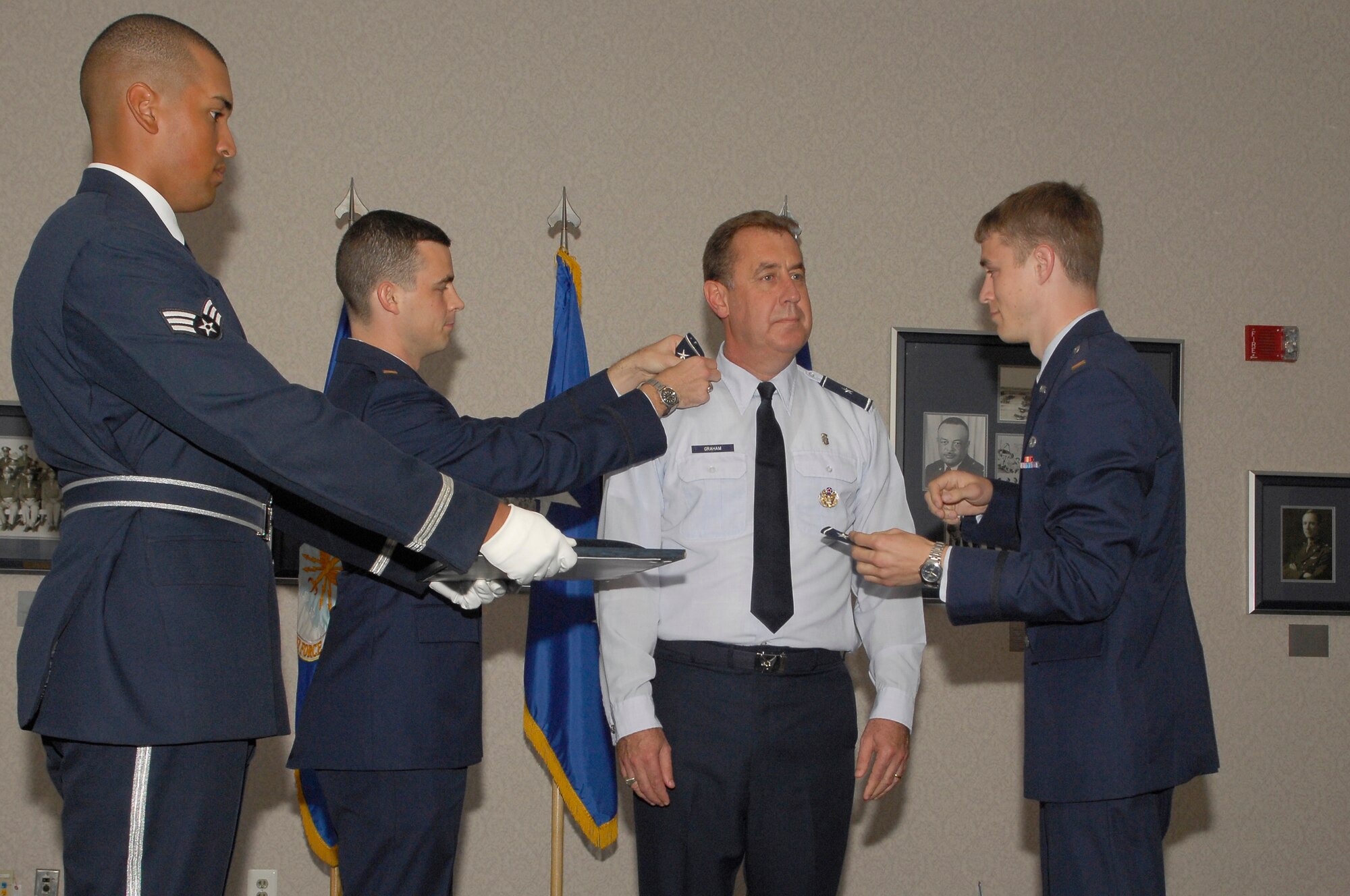 Brig. Gen. (Dr.) Gar S. Graham stands-by as sons 2nd Lt. Ross Graham (left) and 2nd Lt. Hudson Graham (right) replace his 1-star epaulets with those bearing 2 stars during a promotion ceremony Aug. 24 at the Bolling Officers Club. Graham's promotion was confirmed by the Senate Aug. 1.  He is the first Air Force Dental Corps chief to wear the rank of major general. Graham is also the Air Force assistant surgeon for dental services, the Air Force District of Washington command surgeon and the 79th Medical Wing commander at Andrews AFB. U.S. Air Force photo by A1C Alxandre Montes)
