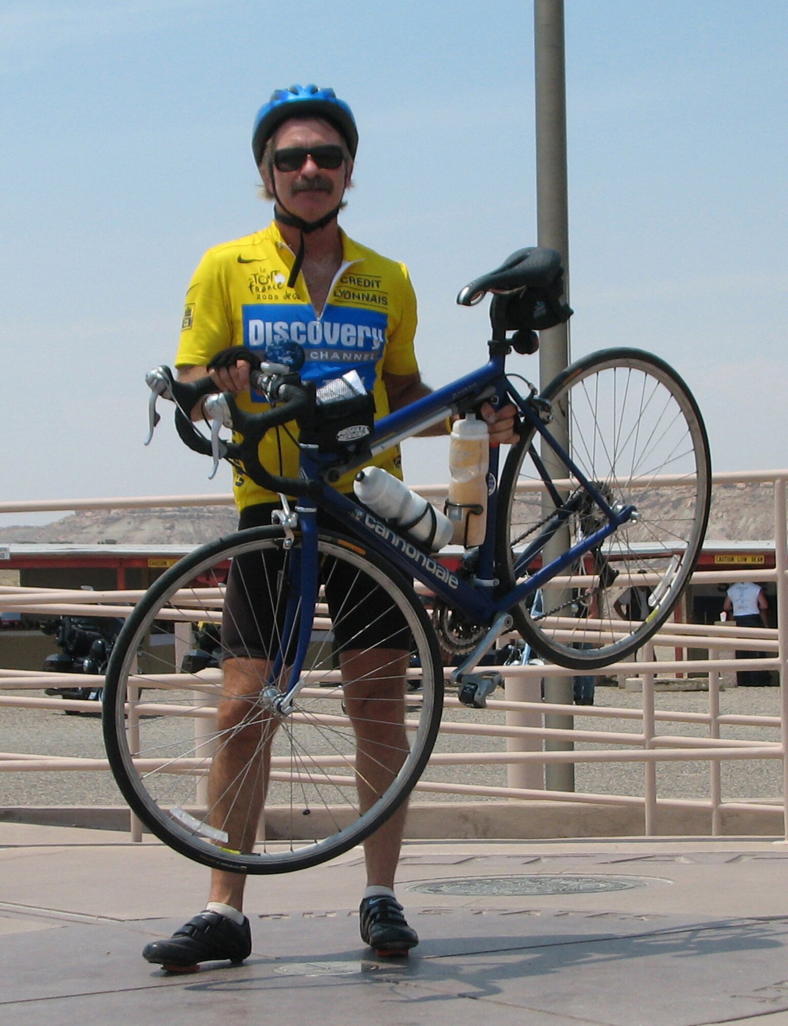 Retired Maj. Dale Weaver stands with his bicycle in four states at one time: Arizona, New Mexico, Utah and Colorado July 10 on a stop during his bicycle journey across the United States. Mr. Weaver completed the cross-country journey in 45 days. (Courtesy photo/Lauren Weaver)