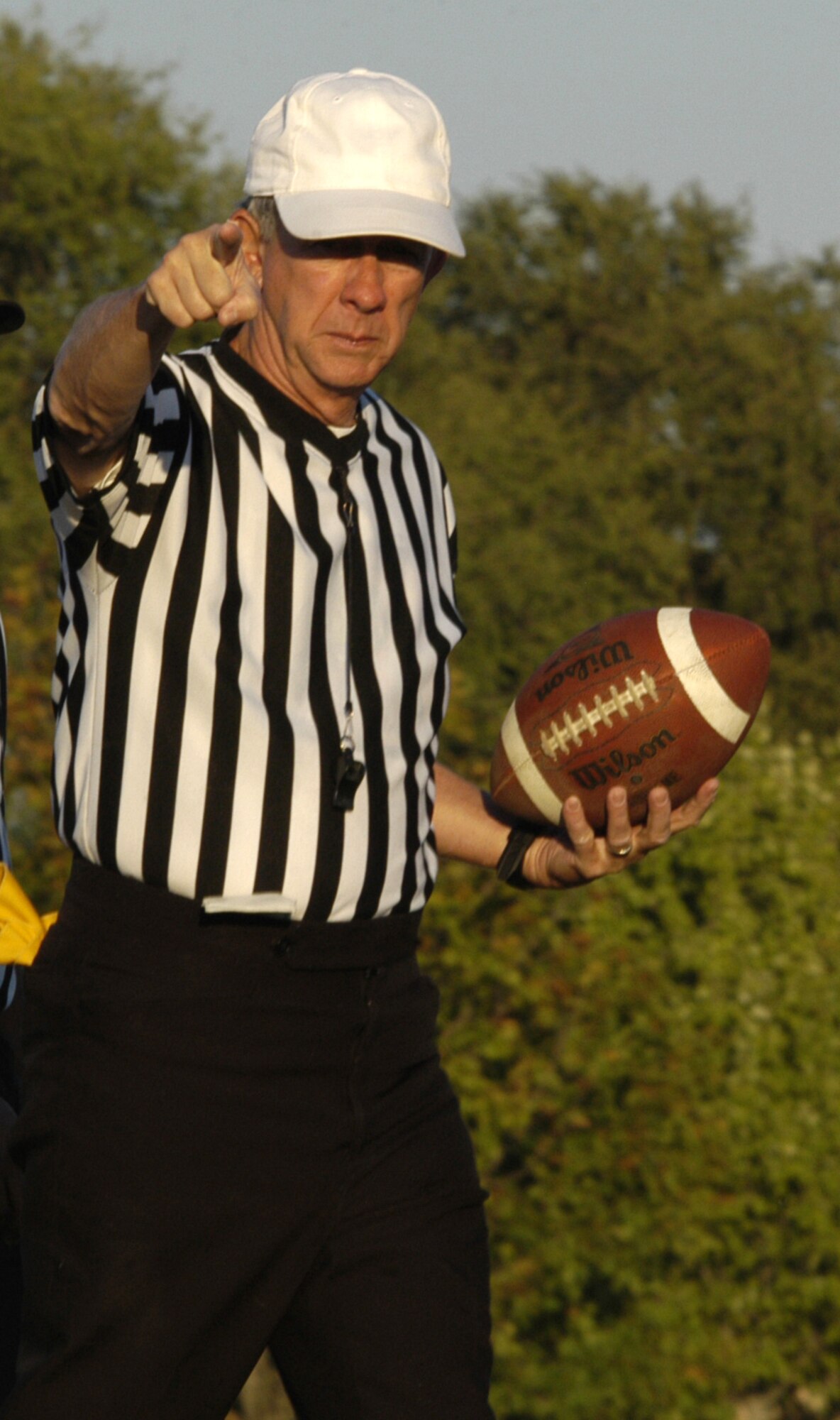 Referee Jay ‘Chief’ Darcey holds the ball and signals a first down for the 436th MDG in Tuesday’s intramural flag football game between the 436th  MDG and 436th APS ‘B’ team. (U.S. Air Force photo/Airman Shen-Chia Chu)
