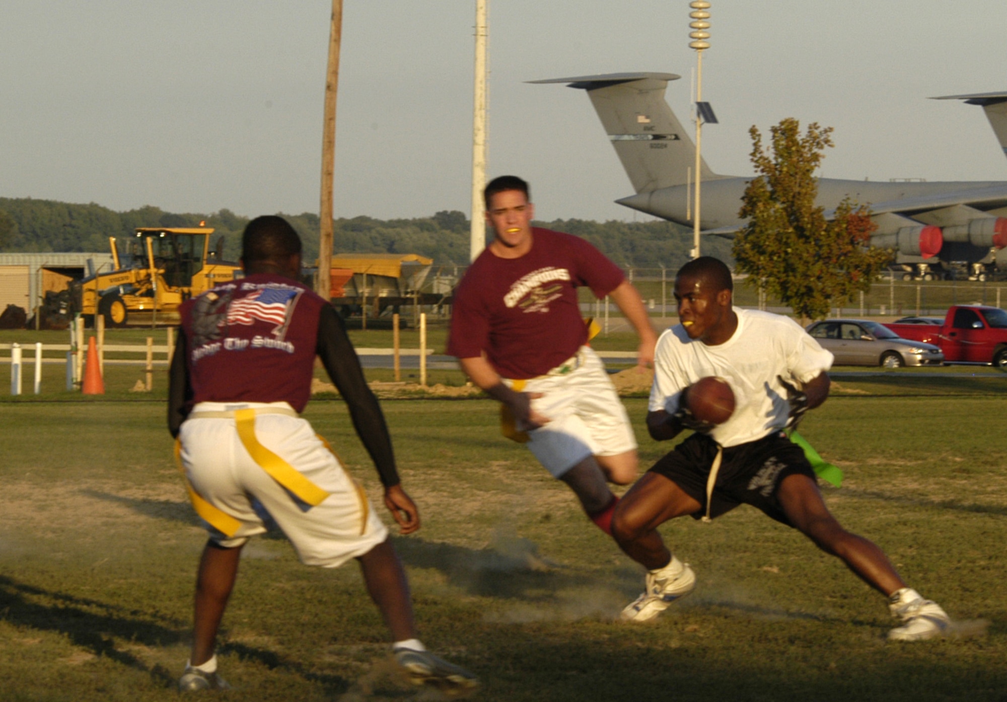 Willis Hoseley and Jamal Wilkinson, 436th Medical Group, defend against Jared ‘the hulk’ Knowlton, 436th Aerial Port Squadron, in an intramural flag football game between the 436th  MDG and 436th APS ‘B’ team Tuesday. The 436th MDG won the game with a score of 20 – 0. Their record is now 3 – 2. Yumon Smartt, 436th MDG coach said he thinks his team has a good chance of making the playoffs.  (U.S. Air Force photo/Airman Shen-Chia Chu)                                   