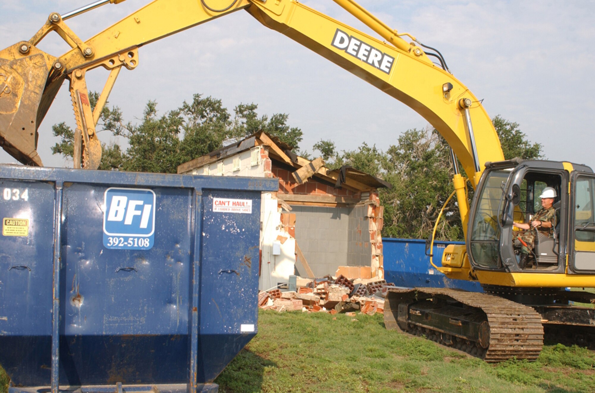 Right, the general gets in the driver’s seat to demolish one of the  golf course facilities damaged by Hurricane Katrina.  He led Keesler’s recovery from nearly $1 billion of damage from the storm. (U.S. Air Force photo by Kemberly Groue)
