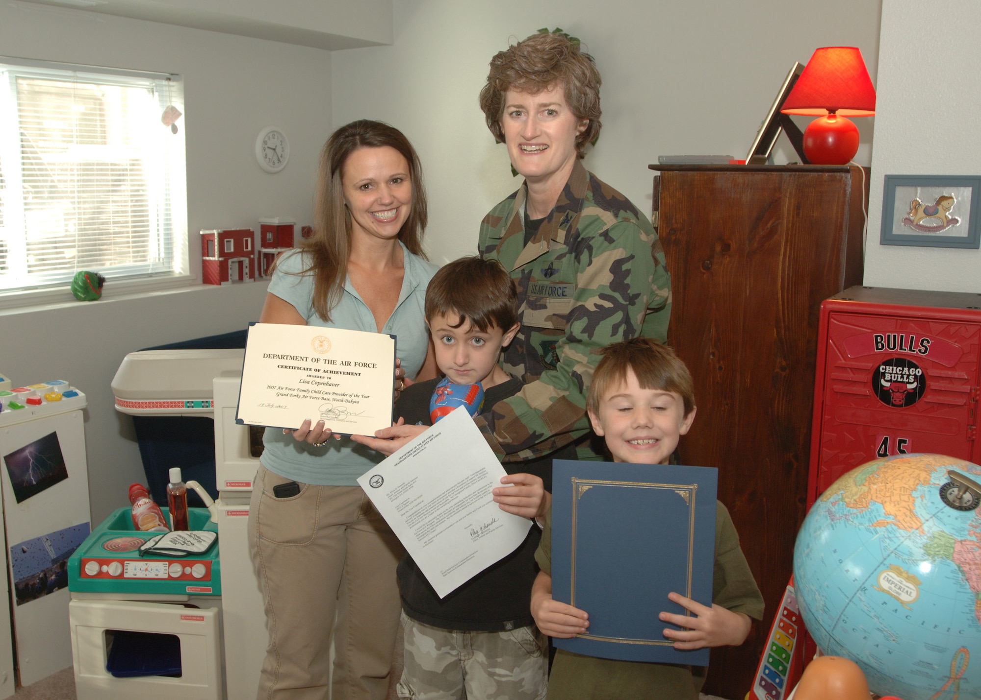 GRAND FORKS AIR FORCE BASE, N.D. -- Lisa Copenhaver, an in-home childcare provider, is presented a certificate of achievement, from Col. Carla Gammon, 319th Mission Support Group Commander, September 26,  2007 for her efforts as a family child care provider. Mrs. Copenhaver won the prestigious Air Force Family Child Care Provider of the Year, Air Mobility Command Family Child Care Provider of the Year, and Grand Forks Family Child Care Provider of the Year awards. (U.S. Air Force phot/Airman 1st Class Chad Kellum)

