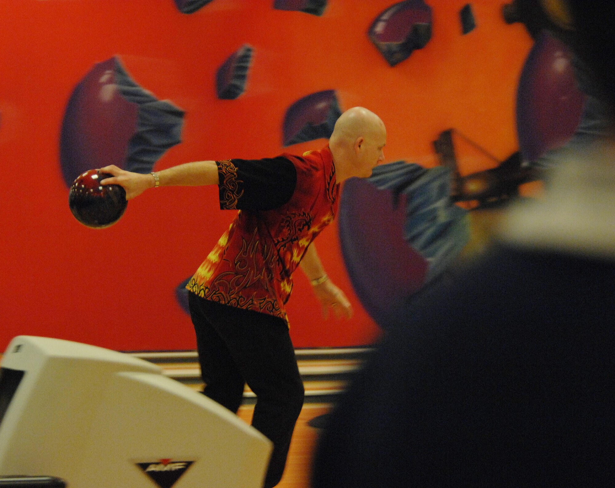 Sporting his firey shirt, Christopher Kitching, stationed at RAF Mildenhall, competes in the 2007 U.S. Air Forces in Europe Bowling Championships hosted at the RAF Mildenhall Bowling Center, in the singles category, Sept. 26. Kitching also competed in the team and doubles categories. (U.S. Air Force Photo by Tech. Sgt. Tracy L. DeMarco)