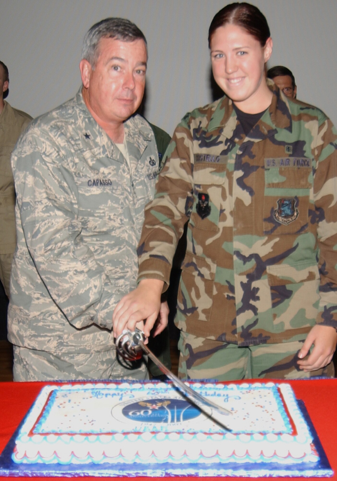 Brig. Gen. Paul Capasso, left, 81st Training Wing commander, and Airman Mary Costello, 81st Medical Operations Squadron, cut the Air Force birthday cake Sept. 18.  Airman Costello, 18, is the youngest permanent-party member assigned to Keesler.  (U.S. Air Force photo by Kemberly Groue)