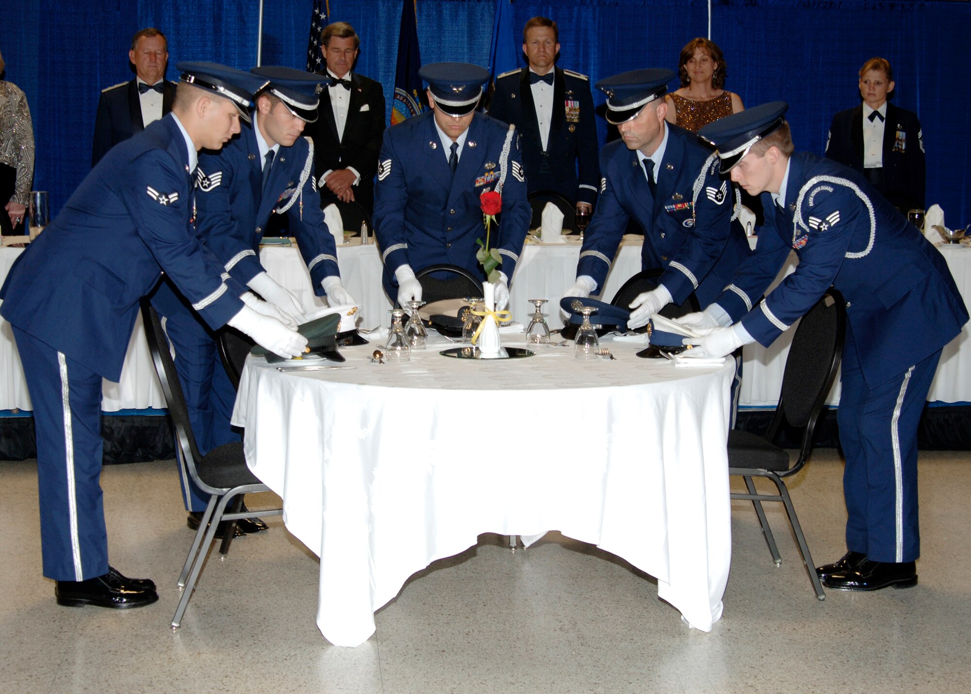 MCCONNELL AIR FORCE BASE, Kan. -- The base Honor Guard team places one hat from each branch service on the Prisoner of War/Missing in Action table during the 60th Anniversary Air Force Ball, Sept. 15, at the Century II Convention center, Wichita. The POW/MIA table symbolizes those lost in combat that could not share in the celebration. (photo by Airman 1st  Class Justin Shelton) 