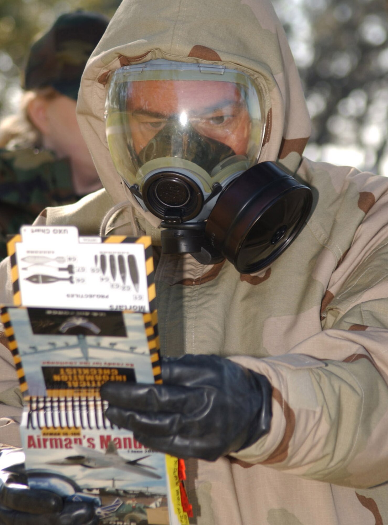 General Capasso reviews the Airman’s Manual during a contingency exercise in preparation for last month’s Operational Readiness Inspection, in which Keesler earned an “excellent” rating.  (U.S. Air Force photo by Kemberly Groue)