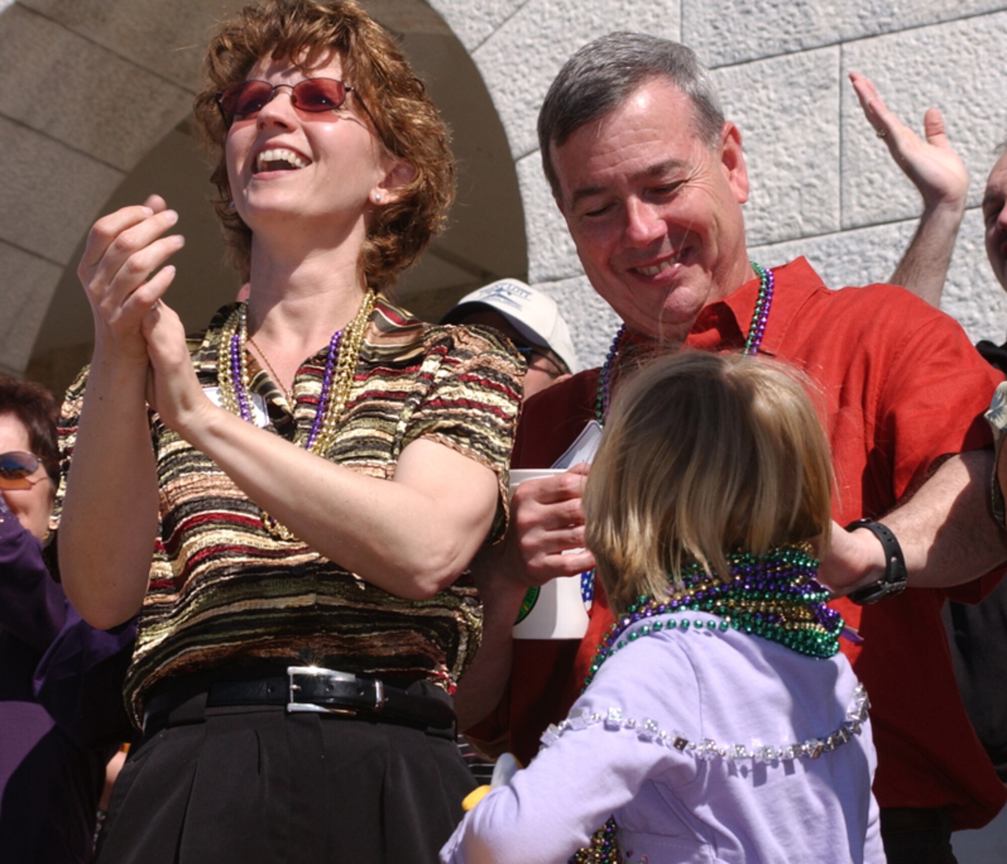 The Capassos and their daughter, Claire, enjoy Biloxi’s Mardi Gras festivities.  (U.S. Air Force photo by Kemberly Groue)