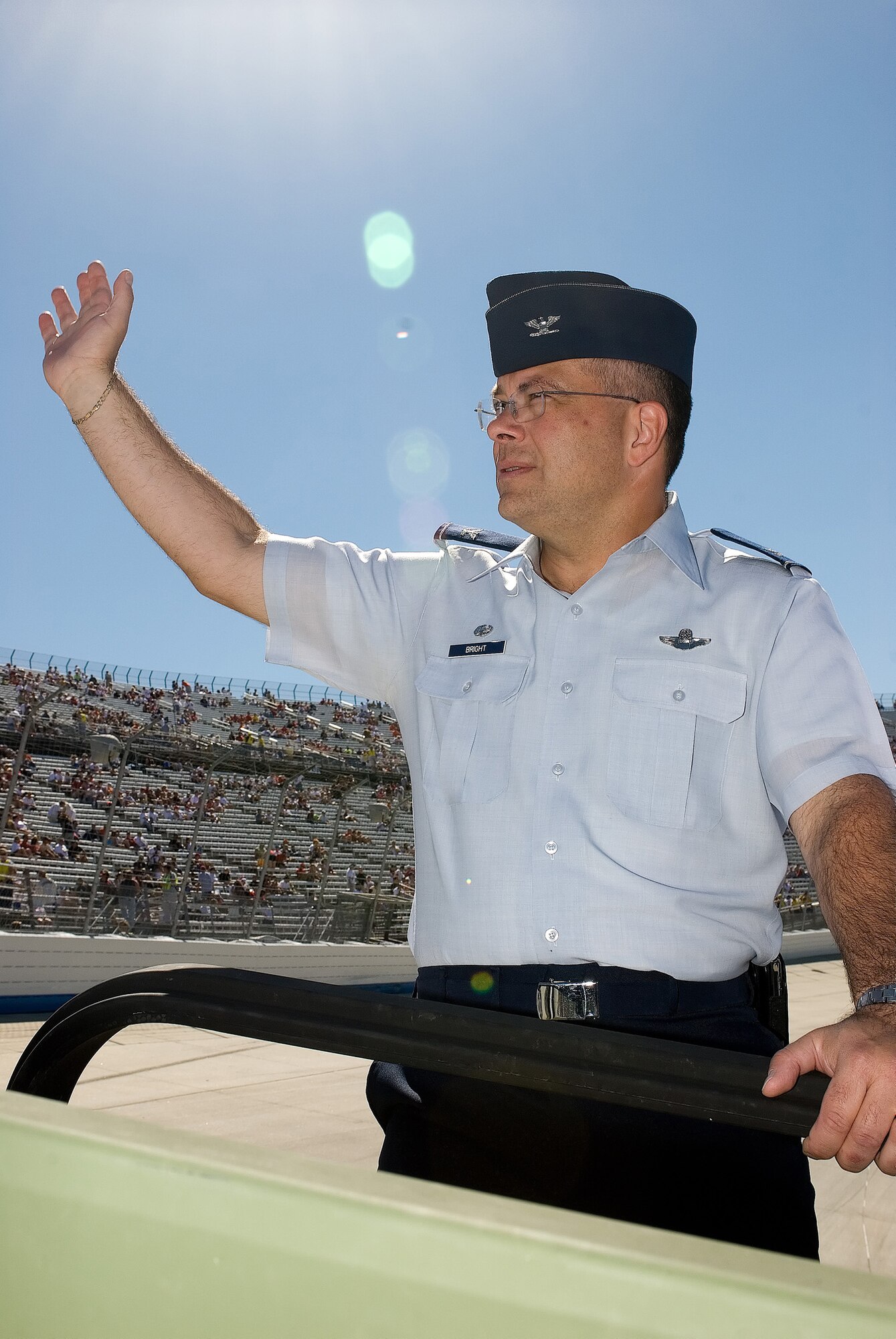 DOVER AIR FORCE BASE, Del.--Col. Randal L. Bright, 512th Airlift Wing commander, waves to a crowd of thousands during the parade lap of the NASCAR Dodge Dealership 400 at the Dover International Speedway. He was joined by Col. Steven Harrison, 436th Airlift Wing commander, in a Humvee driven by Master Sgt. Dave Guenthner of the 512th Civil Engineer Squadron. (U.S. Air Force photo/Roland Balik)