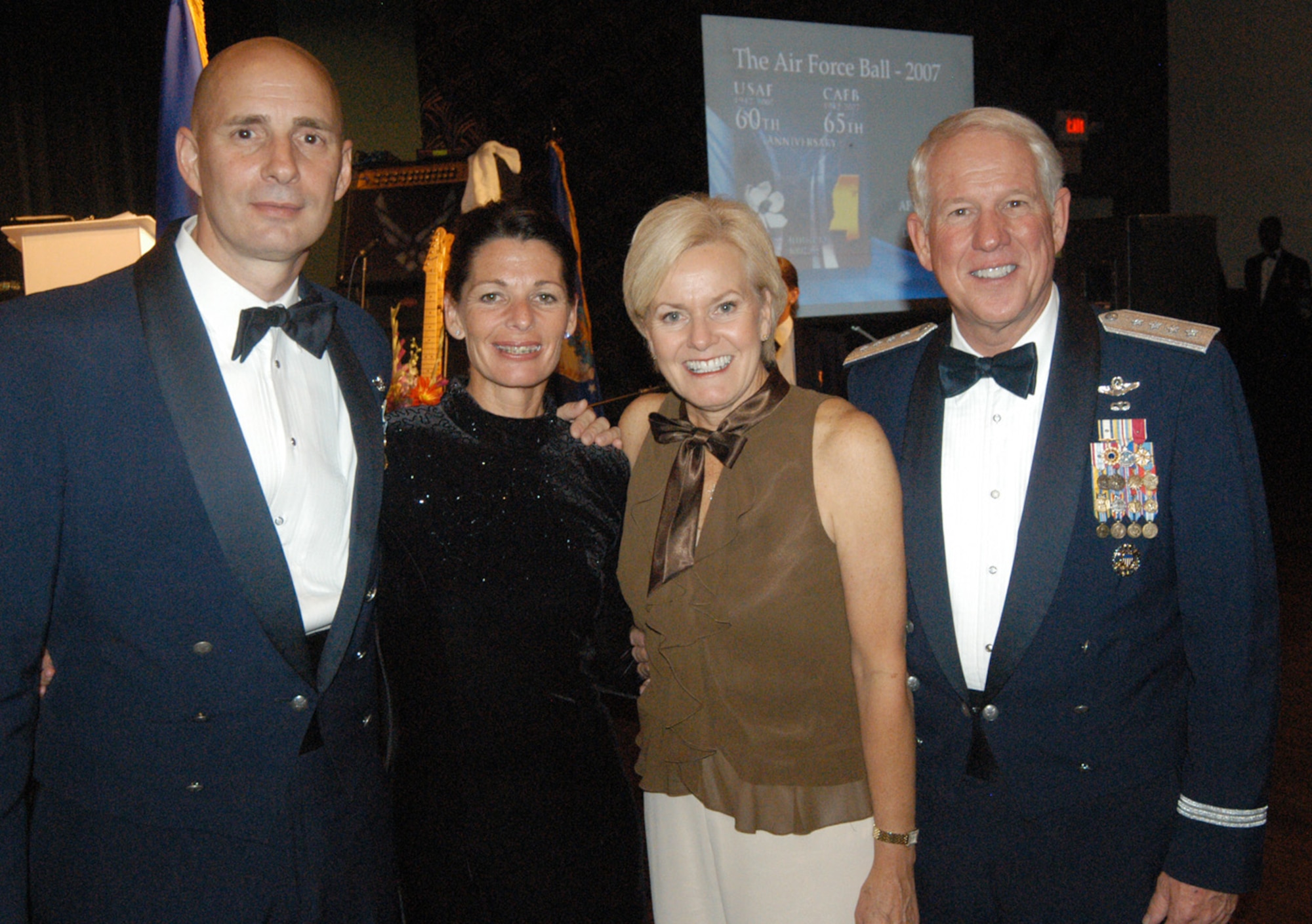 Chief Master Sgt. Mark Luzader, left, Command Chief Master Sergeant of Air Education and Training Command, Terry Luzader, Marilyn Looney and General William Looney, AETC commander, take a moment to pose for a photo Sept. 20 at the Air Force Ball held at the Trotter Convention Center in downtown Columbus, Miss. General Looney and Chief Luzader visited Columbus AFB Thursday and Friday and took part in many of the CAFB 60/65 heritage events that took place. (U.S. Air Force photo by Senior Airman John Parie)
