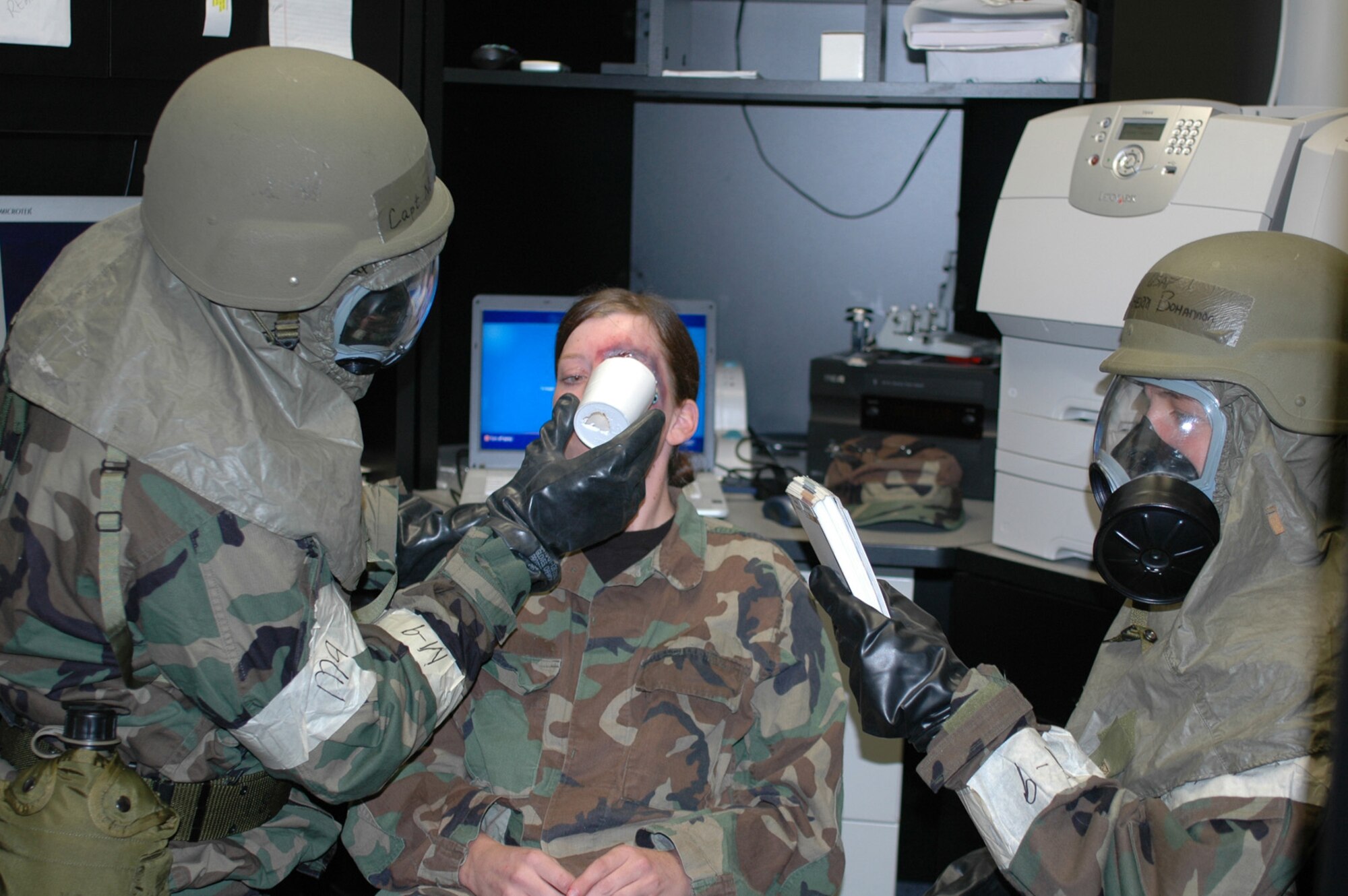 Capt. Newman Robertson and Tech. Sgt. Sherri Bohannon, 917th Wing Public Affairs, use self aid and buddy care procedures to stabilize a fellow Airman with an eye injury during September's 10th Air Force Readiness Assistance Visit Sept. 10-14. (U.S. Air Force photo/Staff Sgt. Ebony Nichols)