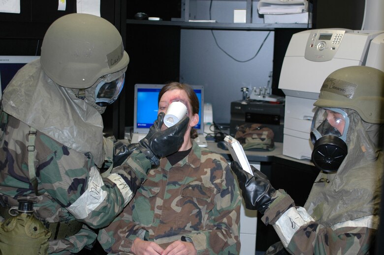 Capt. Newman Robertson and Tech. Sgt. Sherri Bohannon, 917th Wing Public Affairs, use self aid and buddy care procedures to stabilize a fellow Airman with an eye injury during September's 10th Air Force Readiness Assistance Visit Sept. 10-14. (U.S. Air Force photo/Staff Sgt. Ebony Nichols)