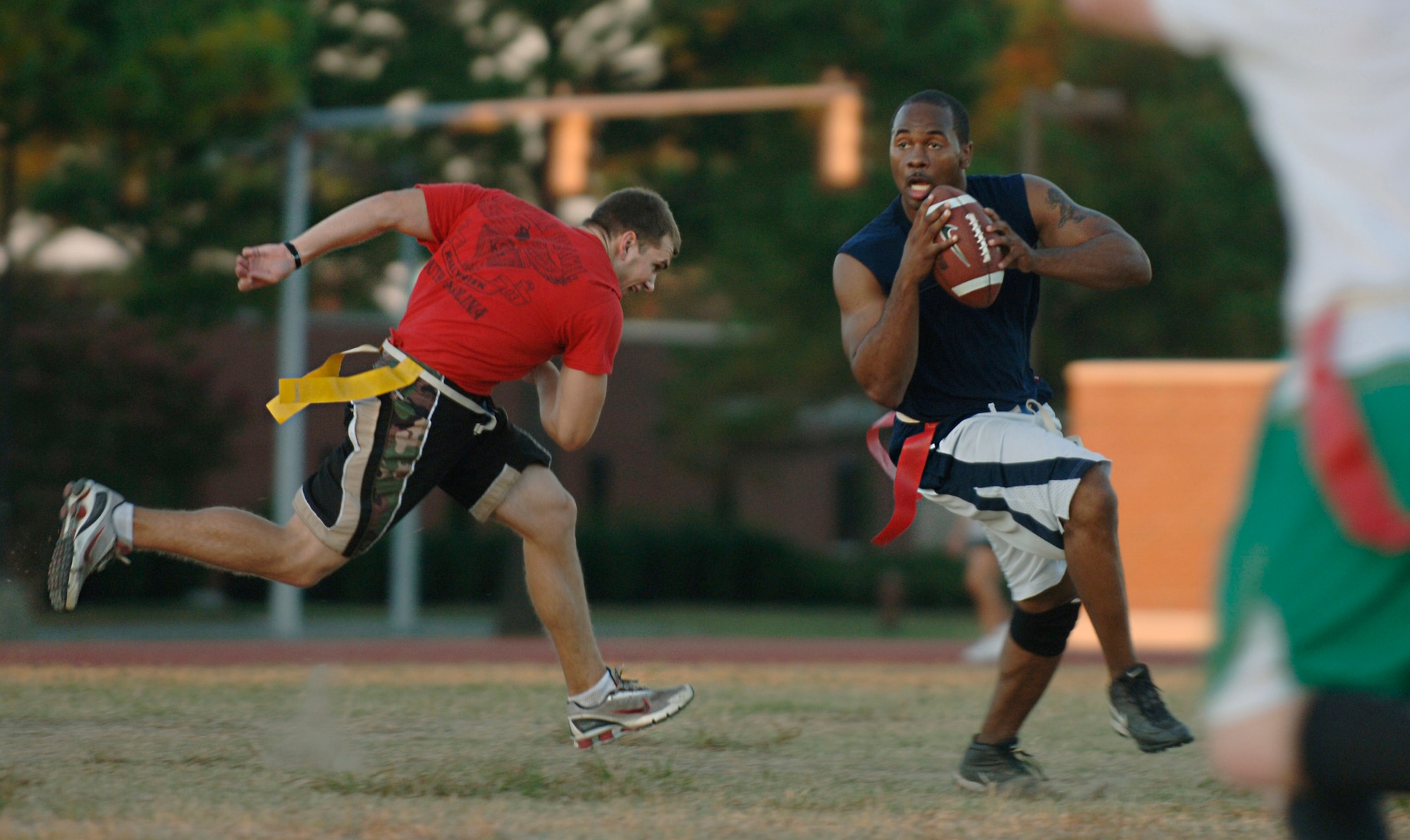 LANGLEY AIR FORCE BASE, Va. -- Quarterback Gerald Davidson, 1st Equipment Maintenance Squadron, attempts to block Corey Dickey of the 1st Medical Group during a flag football game here Sept. 24.  The 1st MDG went on to win the match, 19-7.  (U.S. Air Force photo/Airman 1st Class Vernon Young)