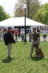 Sgt. Shain E. Nickerson and Lance Cpl. Andrew J. Marcum, Marine working dog handlers with Military Police Support Company, II Marine Headquarters Group shows off Zock, the 22-month-old Patrol Explosive Detection Dog, during a training demonstration at Boston Common, May 4, 2010. The dog handlers showed the Boston citizens a few training tactics and exactly what these dogs are capable of.