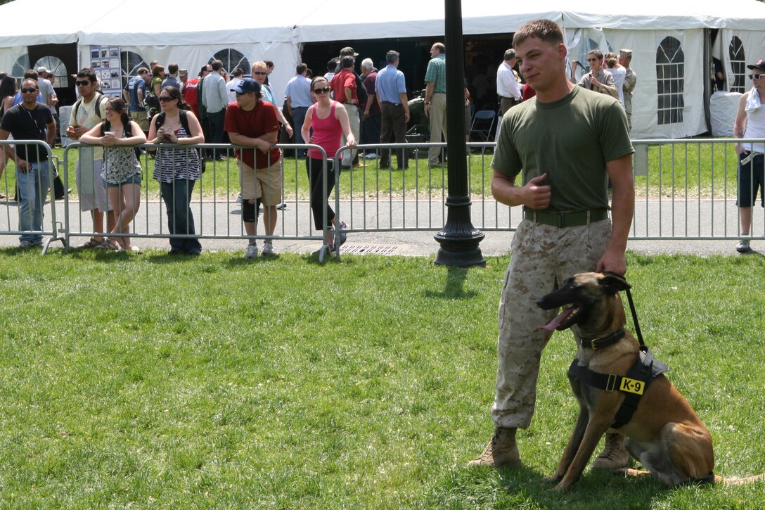 Sgt. Shain E. Nickerson from Rayland, Ohio, a Marine working dog handler with Military Police Support Company, II Marine Headquarters Group handles Zock, the 22-month-old patrol explosive detection dog, at Boston Common, May 4, 2010. The Belgian Malinois showed off his obedience to the Boston citizens during Marine Week.