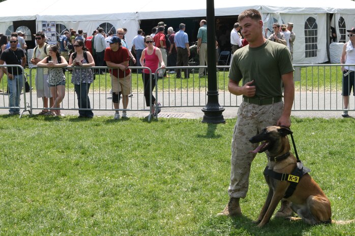Sgt. Shain E. Nickerson from Rayland, Ohio, a Marine working dog handler with Military Police Support Company, II Marine Headquarters Group handles Zock, the 22-month-old patrol explosive detection dog, at Boston Common, May 4, 2010. The Belgian Malinois showed off his obedience to the Boston citizens during Marine Week.