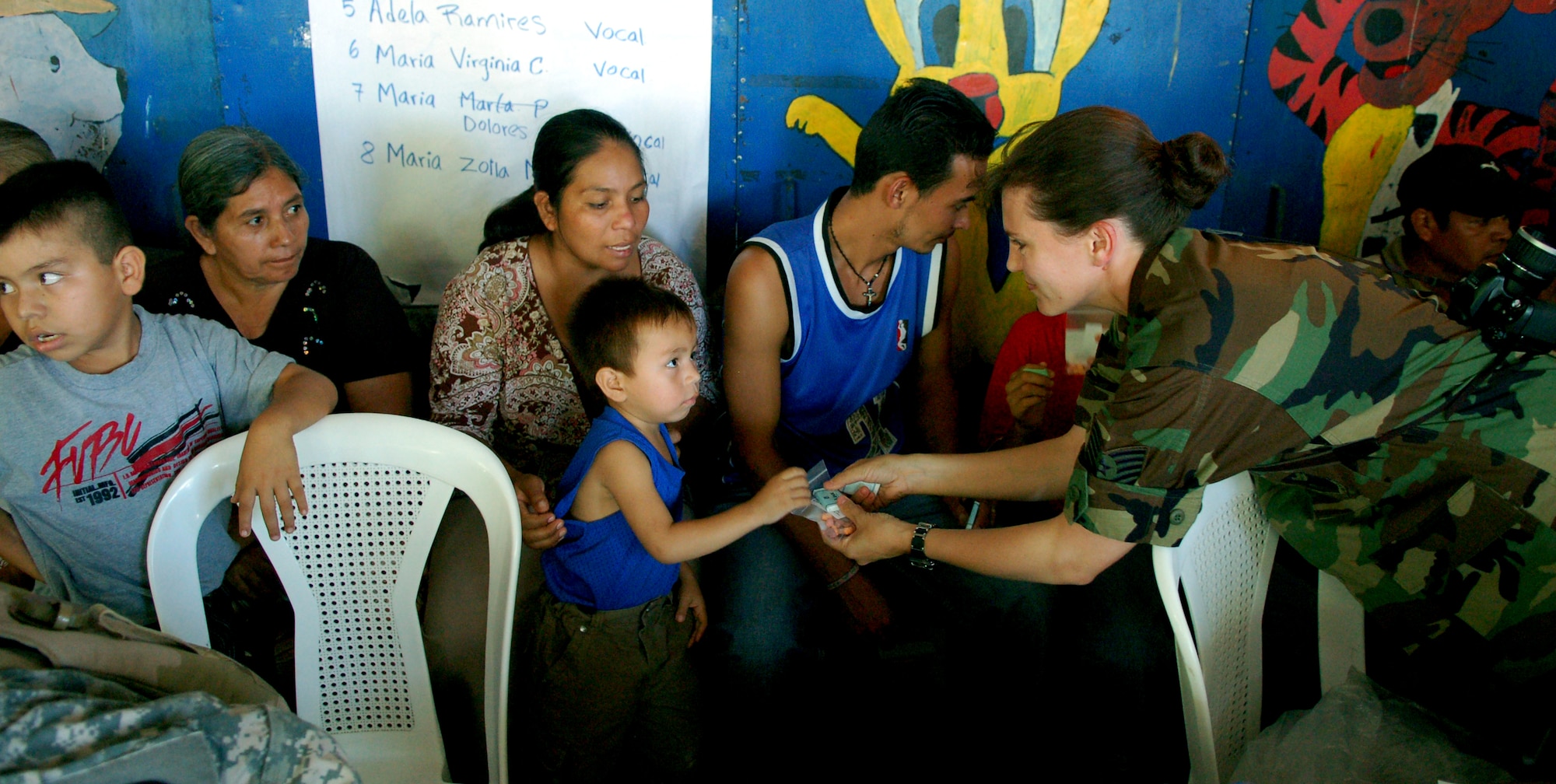 SAN JUAN OPICO, El Salvador – Air Force Tech. Sgt. Angel Roush, Joint Task Force-Bravo Medical Element, hands a bag of vitamins to a young Salvadoran boy at a makeshift clinic where doctors, nurses and medics from the United States and Salvadoran militaries conducted a Medical Readiness Training Exercise Sept. 27.  (U.S. Air Force photo by Staff Sgt. Austin M. May)