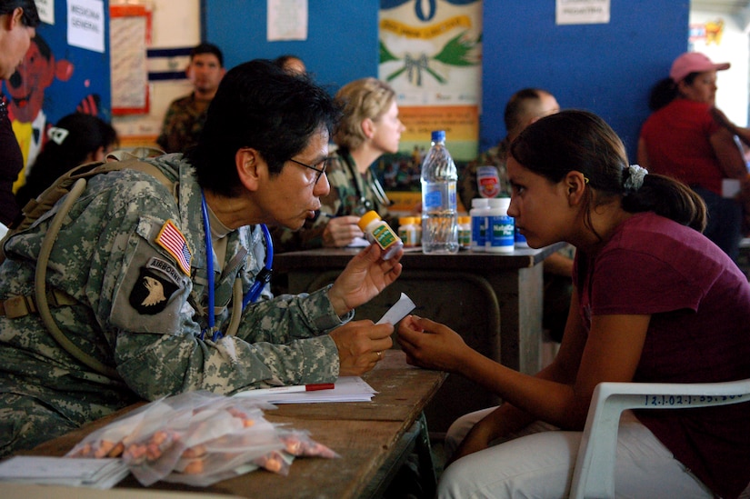 SAN JUAN OPICO, El Salvador – Army Capt. Marta Artiga, Joint Task Force-Bravo Medical Element, explains multivitamin dosage directions to Gabriela Alejandra, 13, at a makeshift clinic where doctors, nurses and medics from the United States and Salvadoran militaries conducted a Medical Readiness Training Exercise Sept. 27.  (U.S. Air Force photo by Staff Sgt. Austin M. May)