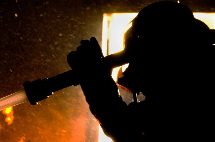Dowsing the Flames, Marine Pvt. Oscar Bonilla fights a building fire during training. (Photo by Tech. Sgt. Matthew Hannen)